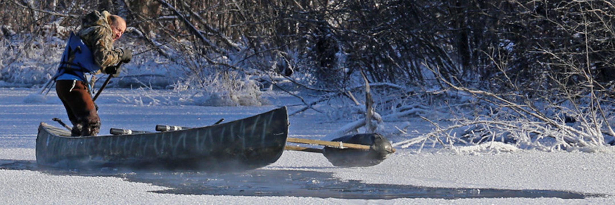 Wendell Diller used a push pole to propel his canoe through a spot of open water while retrieving a downed goose.