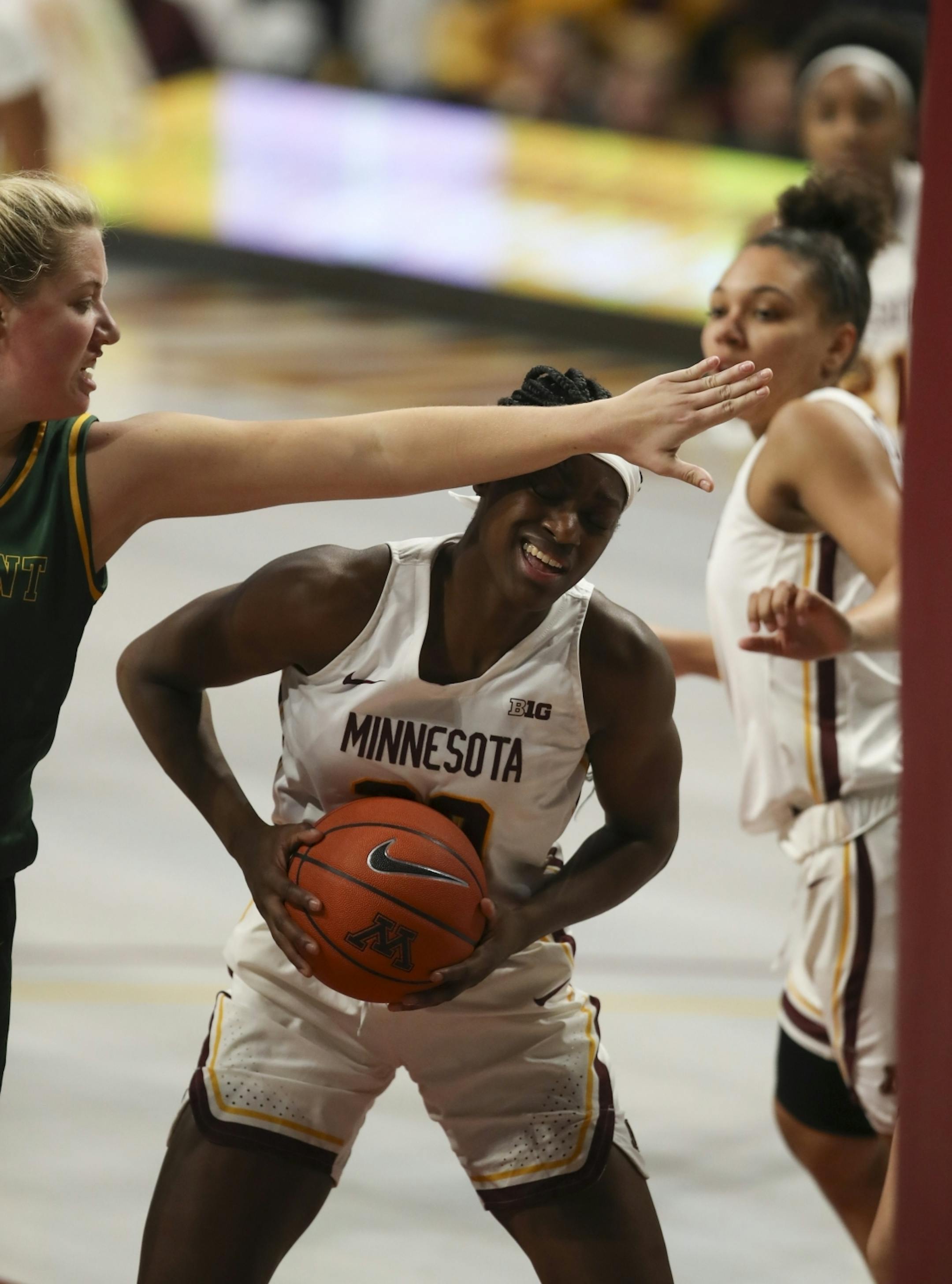 Minnesota Golden Gophers forward Kehinde Bello (20) was defended by Vermont Catamounts forward Abby Settelmeyer (25) when she attempted to shoot under the net in the second quarter.