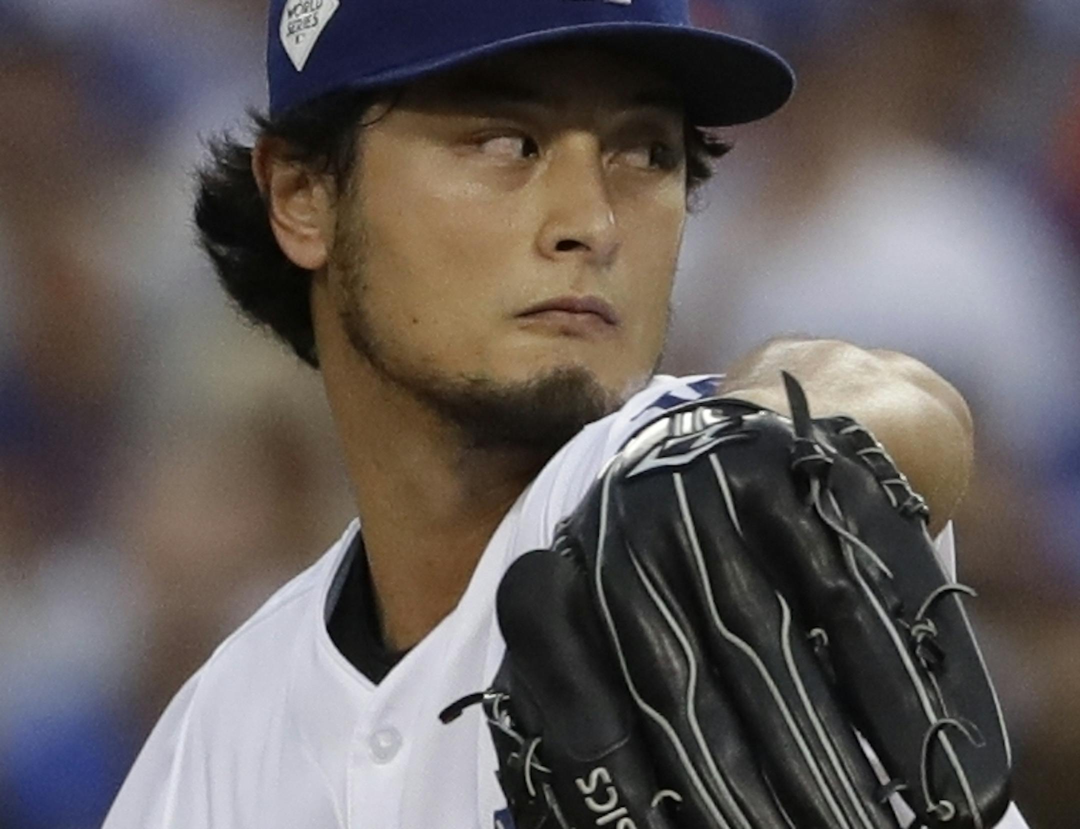 FILE - In this Nov. 1, 2017, file photo, Los Angeles Dodgers starting pitcher Yu Darvish throws during the first inning of Game 7 of baseball's World Series against the Houston Astros, in Los Angeles. Perhaps 100 free agents still seek contracts as the start of spring training workouts on Feb. 14 draws near, a group that includes J.D. Martinez, Eric Hosmer, Mike Moustakas, Jake Arrieta and Yu Darvish. (AP Photo/Matt Slocum, File)