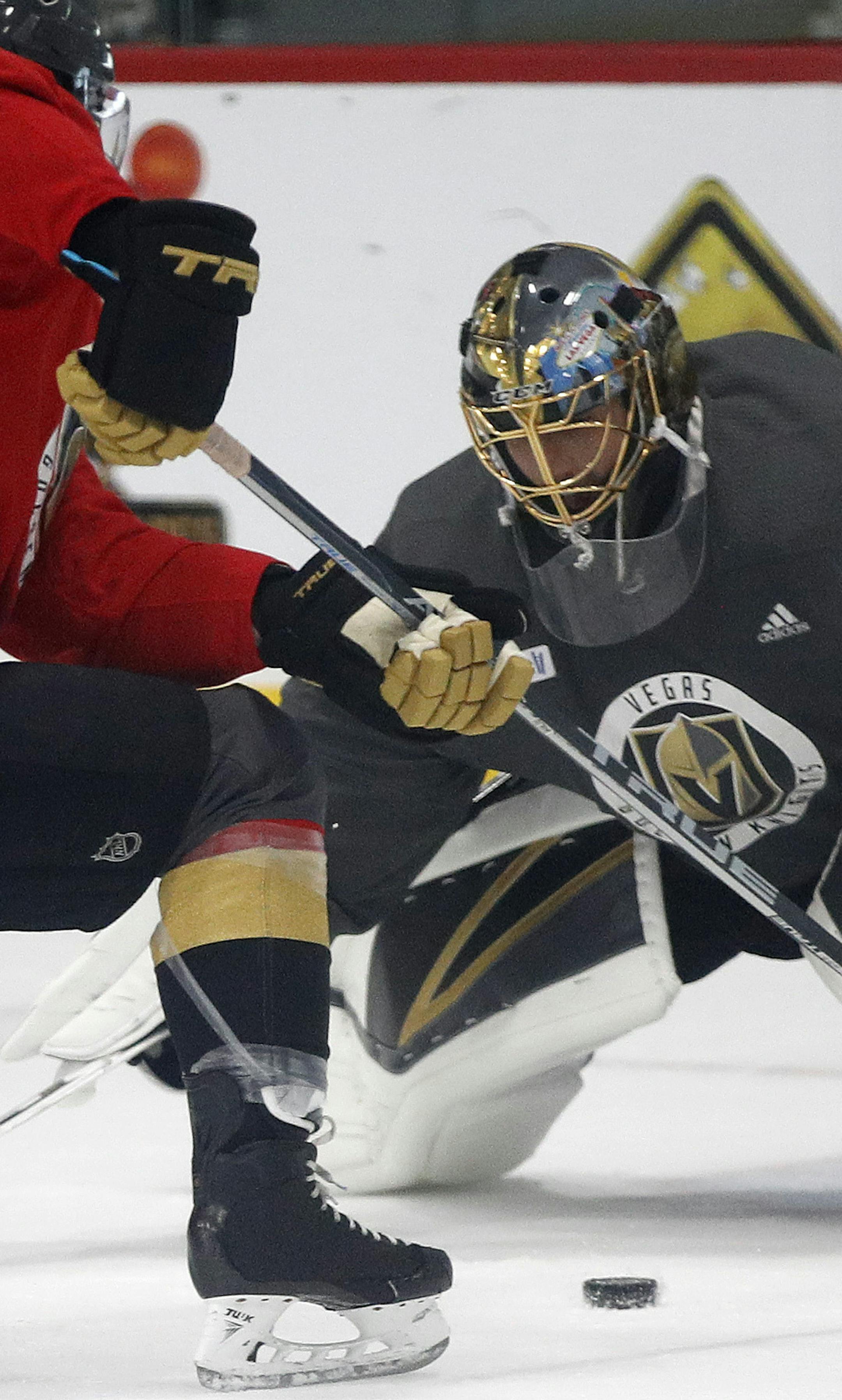 Vegas Golden Knights goaltender Marc-Andre Fleury blocks a shot during an NHL hockey practice, Sunday, May 27, 2018, in Las Vegas. (AP Photo/John Locher)