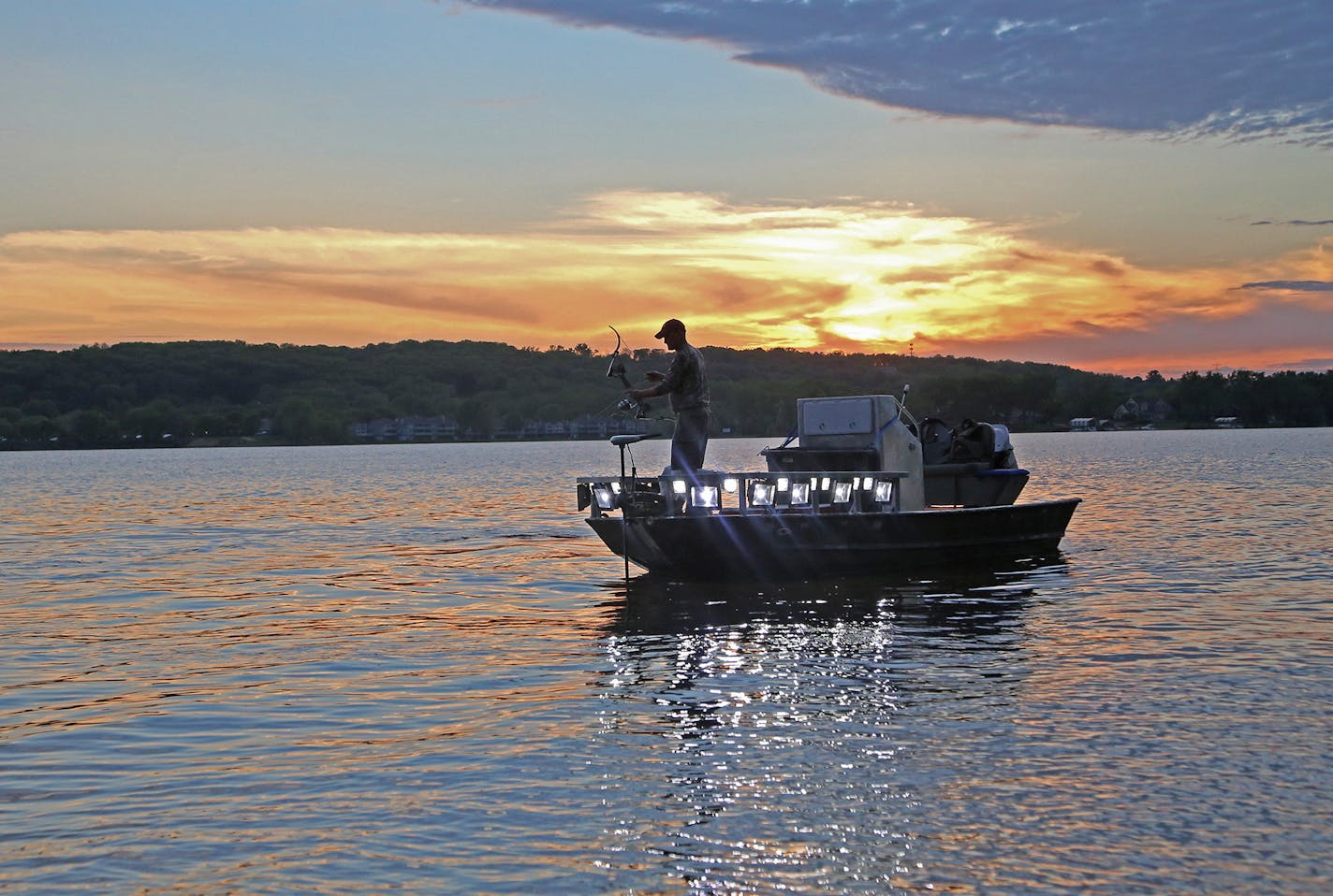 In his custom-made boat, bow at the ready, Mark Ellenberg hugged the St. Croix River shoreline last week looking for carp. Bighead carp were found last week at the farthest point north on the river.