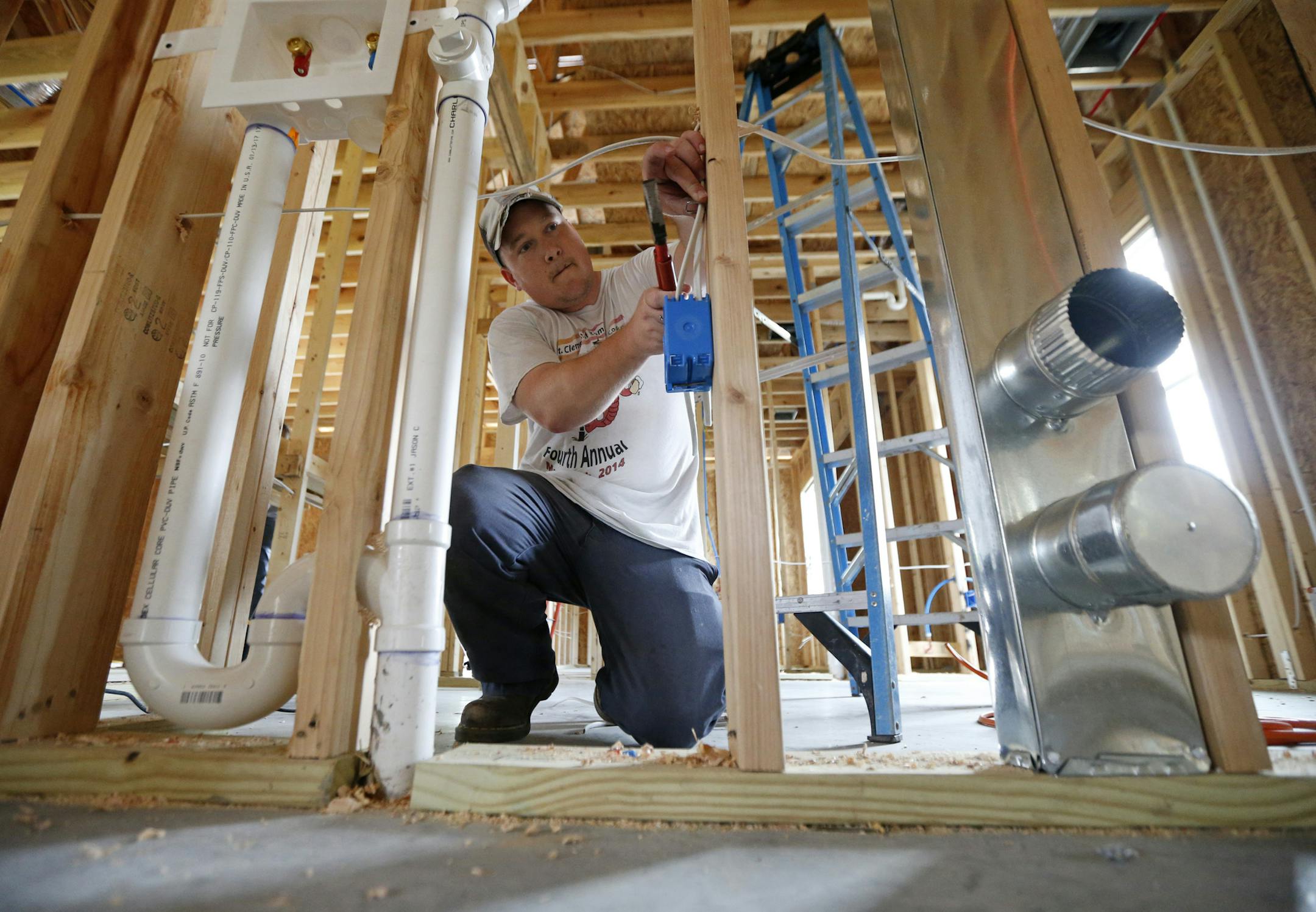 In this Friday, March 24, 2017, photo, Chris Piazza, an electrician with Tasch Electric, works on a home being built by Zach Tyson of Tyson Construction, in Destrahan, La. General contractors and other small businesses in the remodeling industry can look forward to strong growth in the coming years, but the big force behind that business may be surprising: baby boomers. Tyson estimates that between 30 percent and 40 percent of his revenue is coming from boomer renovations, up from 15 percent to