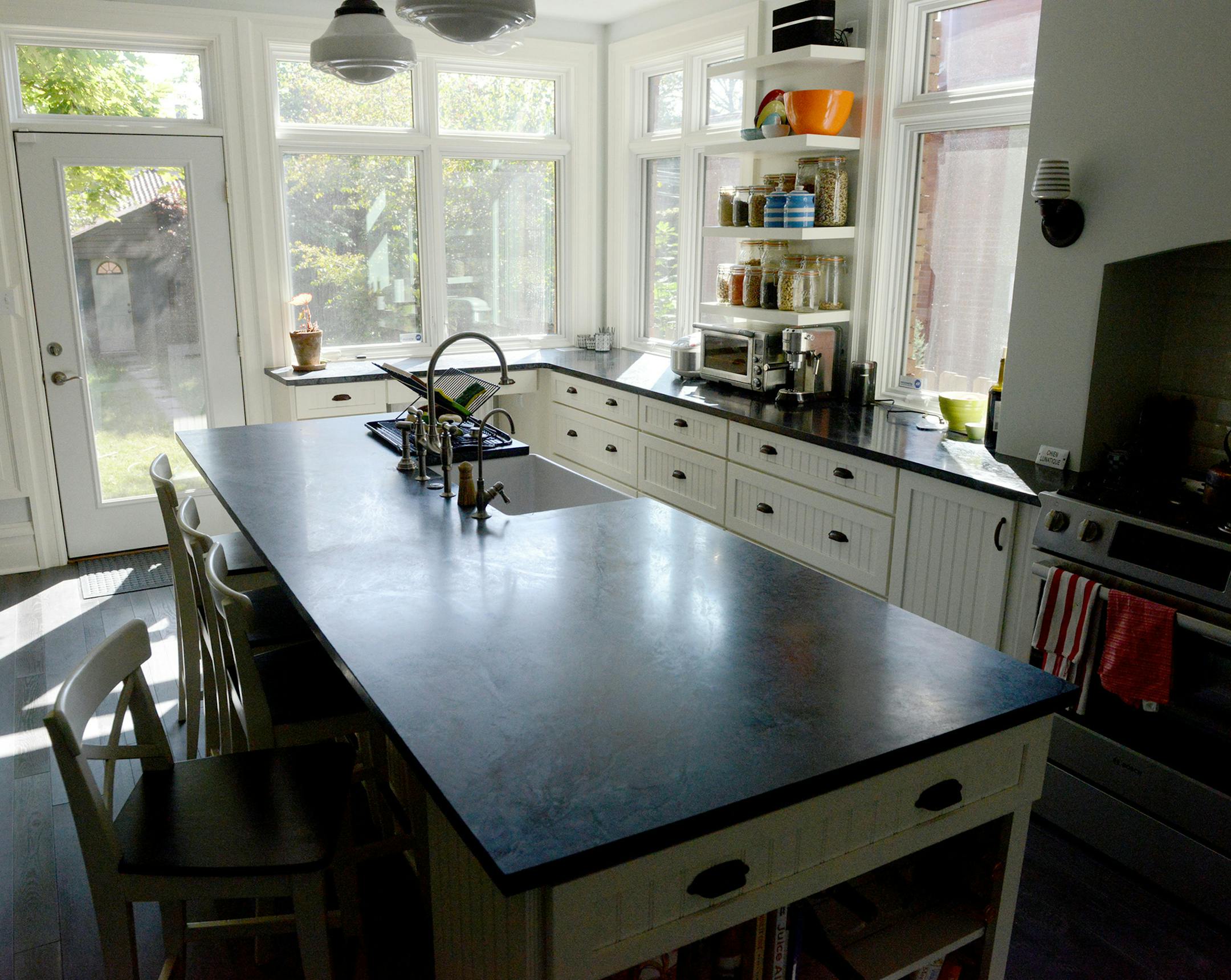 The kitchen features soapstone counters and tall windows. (Michael Henninger/Pittsburgh Post-Gazette/TNS) ORG XMIT: 1174451