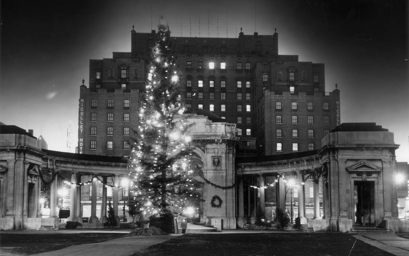 Very little identification on photo, except that it is the Gateway. Illegible writing on back says something like Miller & Marcus. Photo itself shows the Nicollet Hotel behind the Gateway, a Christmas tree in front of the Gateway, and (very faintly) the "NW" of the Northwestern National Bank "weatherball," background lower left. Star Tribune file photo (most likely a staff photo), with a stamp on back showing that it went through the engraving room on Dec. 5, 1949.