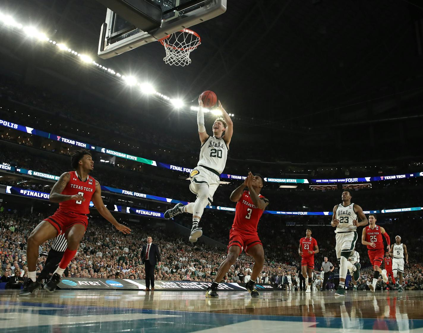 Michigan State guard Matt McQuaid (20) drove against Texas Tech guard Kyler Edwards (0) and Texas Tech forward DeShawn Corprew (3) during the first half. ] CARLOS GONZALEZ &#xa5; carlos.gonzalez@startribune.com Texas Tech played Michigan State in a semifinal of the NCAA Division I Men's Basketball Championship Final Four on Saturday, April 6, 2019 at U.S. Bank Stadium in Minneapolis.