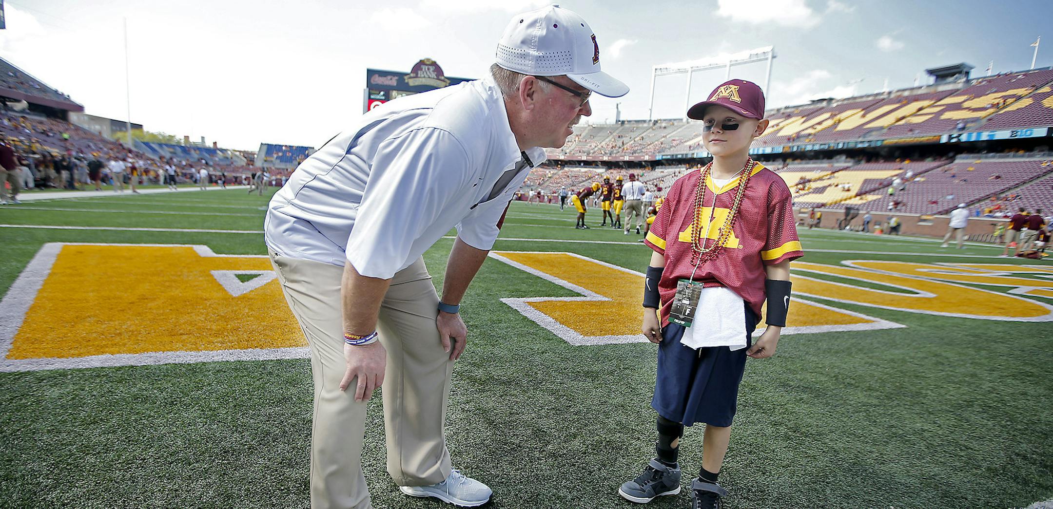 Griffin, 7, of Jordan, MN, was a special guest as the TCF Bank Kickoff Kid, was able to get on the field and meet with players and coaches including Jerry Kill before the Gophers took on Ohio at TCF Bank Stadium, Saturday, September 26, 2015 in Minneapolis, MN. Griffin has Ewing Sarcoma. ] (ELIZABETH FLORES/STAR TRIBUNE) ELIZABETH FLORES • eflores@startribune.com ORG XMIT: MIN1509261420470272