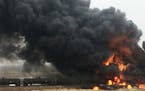 CORRECTS NAME OF SOURCE TO CURT BENSON INSTEAD OF CURT BEMSON - This photo provided by Curt Benson shows smoke and fire coming from an oil train that 