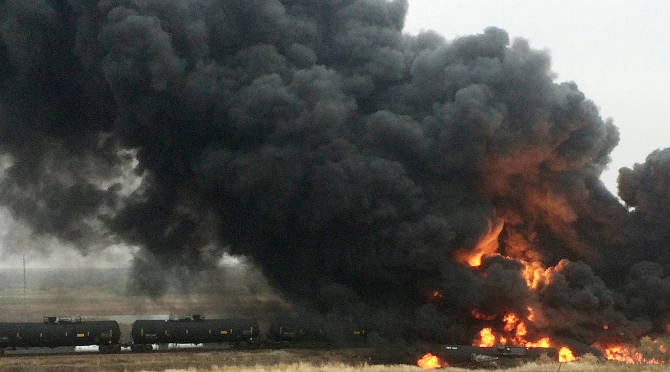 CORRECTS NAME OF SOURCE TO CURT BENSON INSTEAD OF CURT BEMSON - This photo provided by Curt Benson shows smoke and fire coming from an oil train that derailed, Wednesday, May 6, 2015, in Heimdal, N.D. Officials say 10 tanker cars on the BNSF caught fire prompting the evacuation of Heimdal where about three dozen people live. No injuries were reported. (Curt Benson via AP) ORG XMIT: MIN2015050613401949 ORG XMIT: MIN1505061349350496