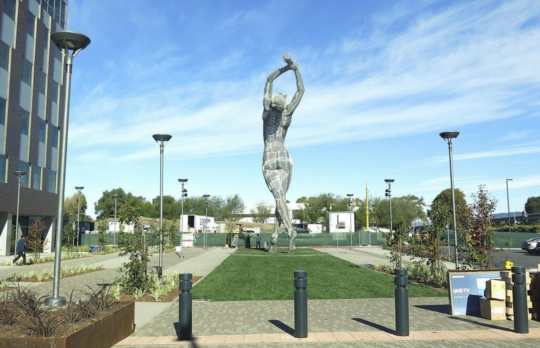 In this photo taken Wednesday Oct. 19, 2016, a 55-foot nude statue stands in San Leandro, Calif. The statue of a naked woman is stirring controversy and a lot of conversation. City officials and the sculptor of the steel nude, which was unveiled this week across from San Leandro's main commuter train stop, say they want to draw attention to "feminine energy." Critics say the 13,000-pound towering nude is not appropriate public art.