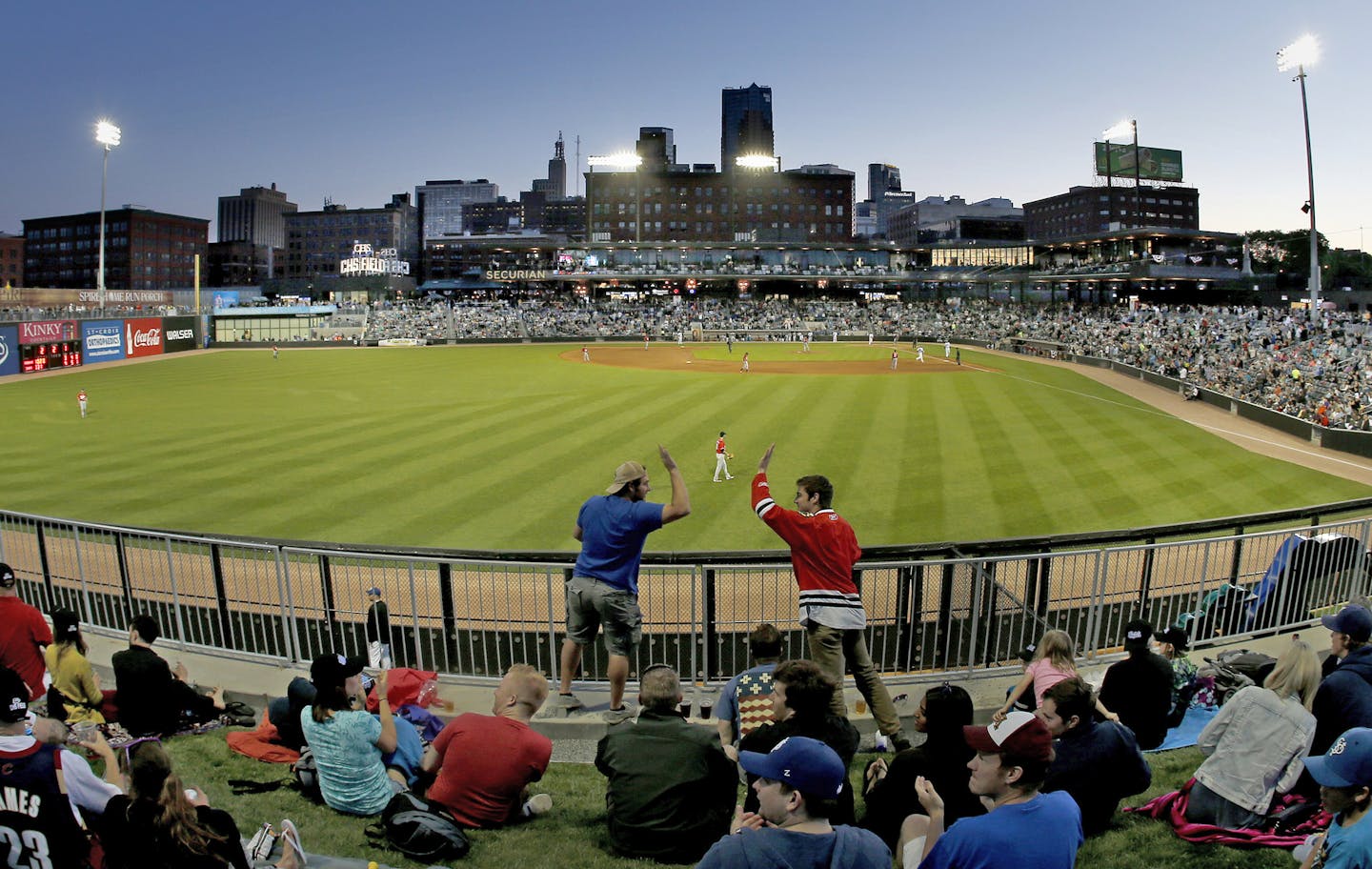 Fans celebrated a home run in the fourth inning of the first game at the St. Paul Saints new ballpark, CHS Field.