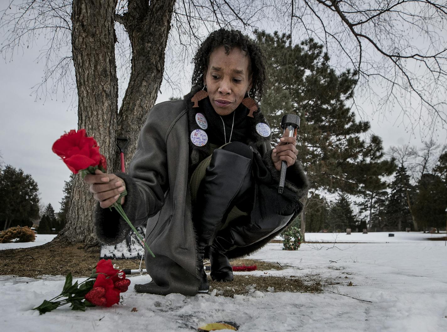 Kim Ambers placed flowers at the gravesite her son Richard Ambers at Crystal Lake Cemetery. ] CARLOS GONZALEZ &#xef; cgonzalez@startribune.com - Minneapolis, MN - Kim Ambers at Crystal Lake Cemetery, where her son, Richard Ambers, is buried. Richard was shot twice in the head in Minneapolis in 2016 during a marijuana-deal-gone-bad.