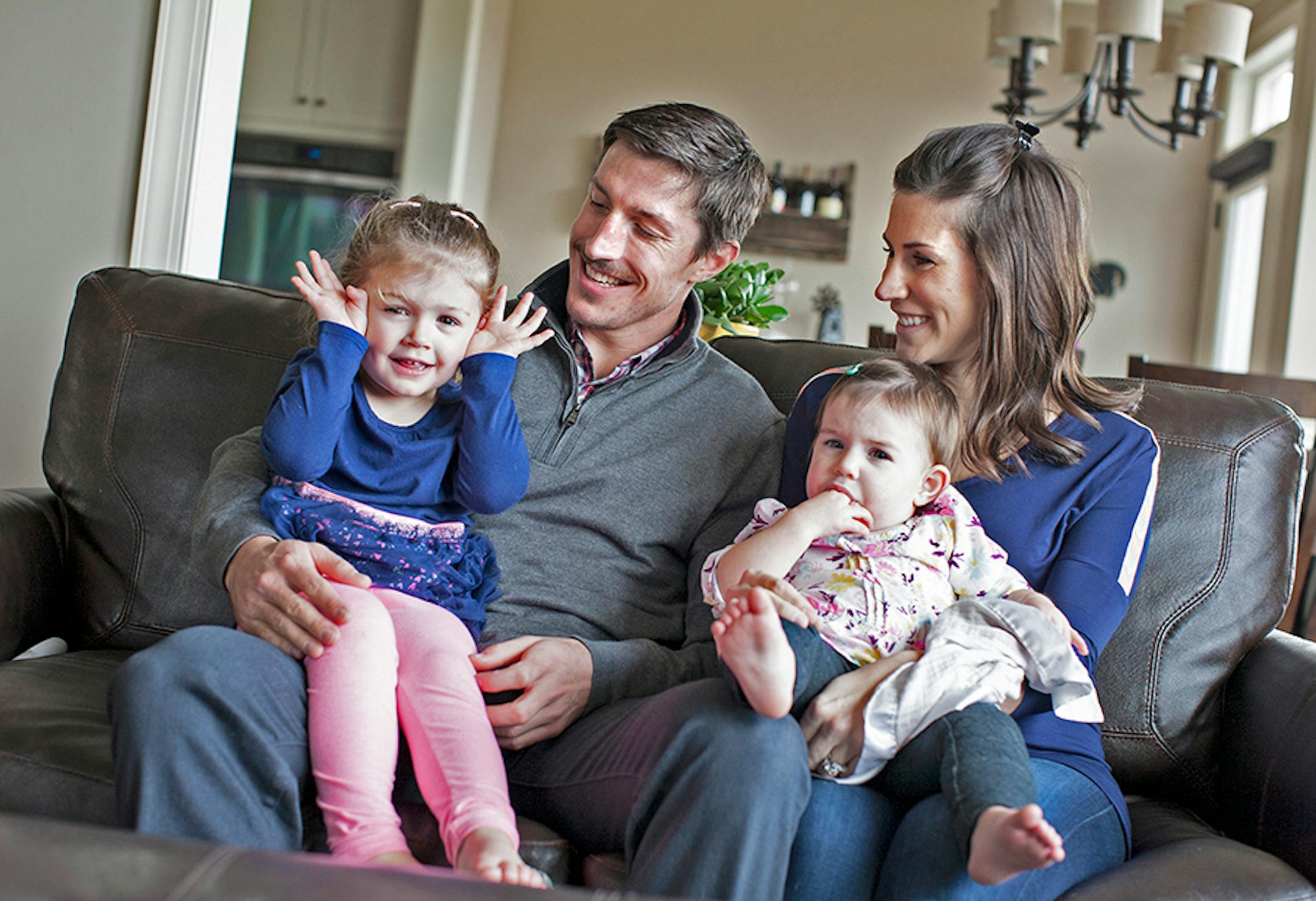 Minnesota Wild's Ryan Carter poses for a family photo with wife Erin and daughters Maggie, 3, left, and Natalie, 15 months, at their home in Gem Lake November 22, 2015.