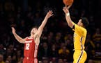 Wisconsin's Trevor Anderson guards against a three-point shot by Minnesota's Payton Willis during the second half on Feb. 5