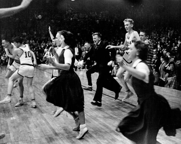 December 25, 1960 ***** the floor of Williams arena raced Edgerton, Minn., players, cheerleaders and coach (young Richard Olson, 23) after the Flying 