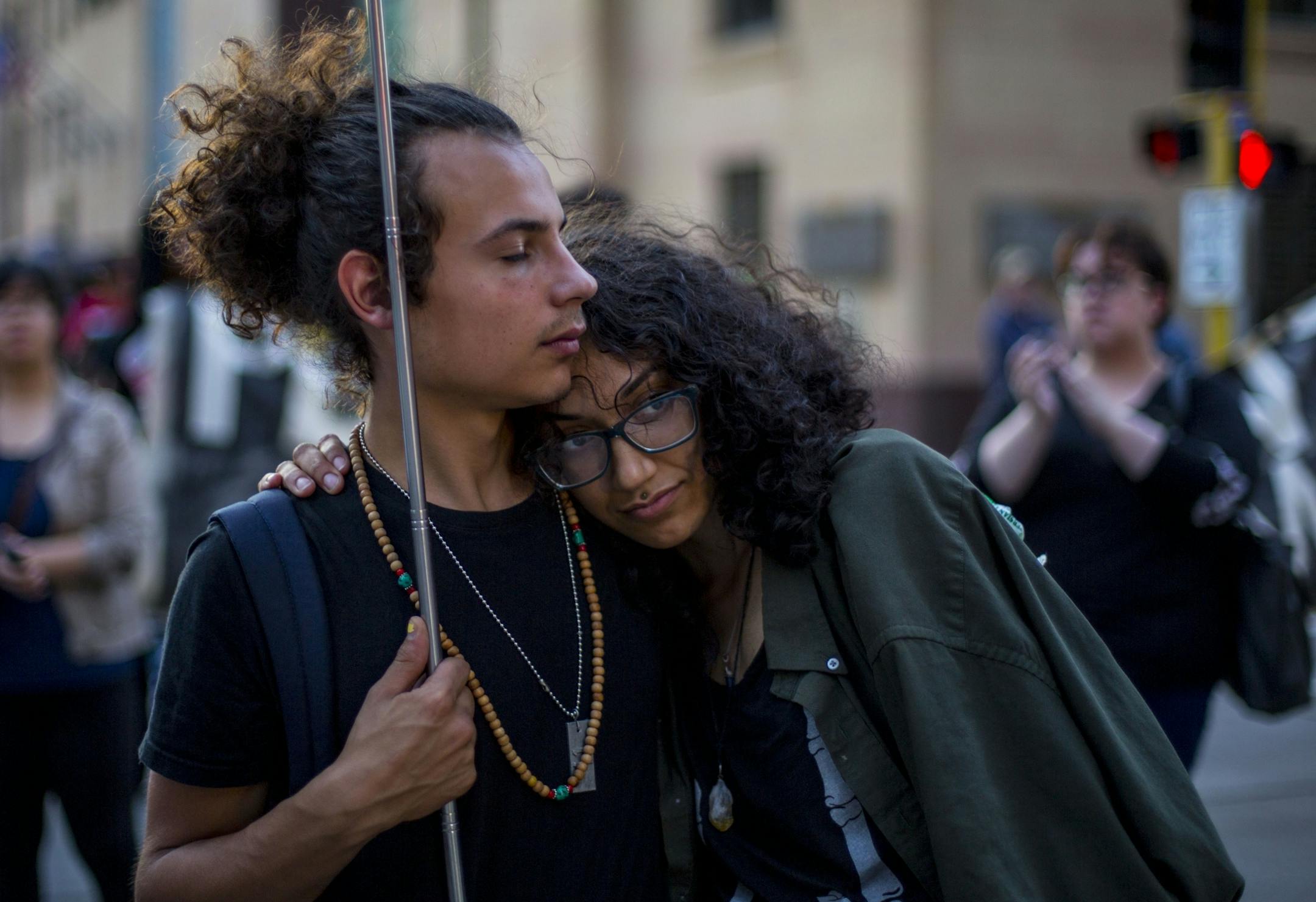 Two protestors hold one another as the march comes to an end.