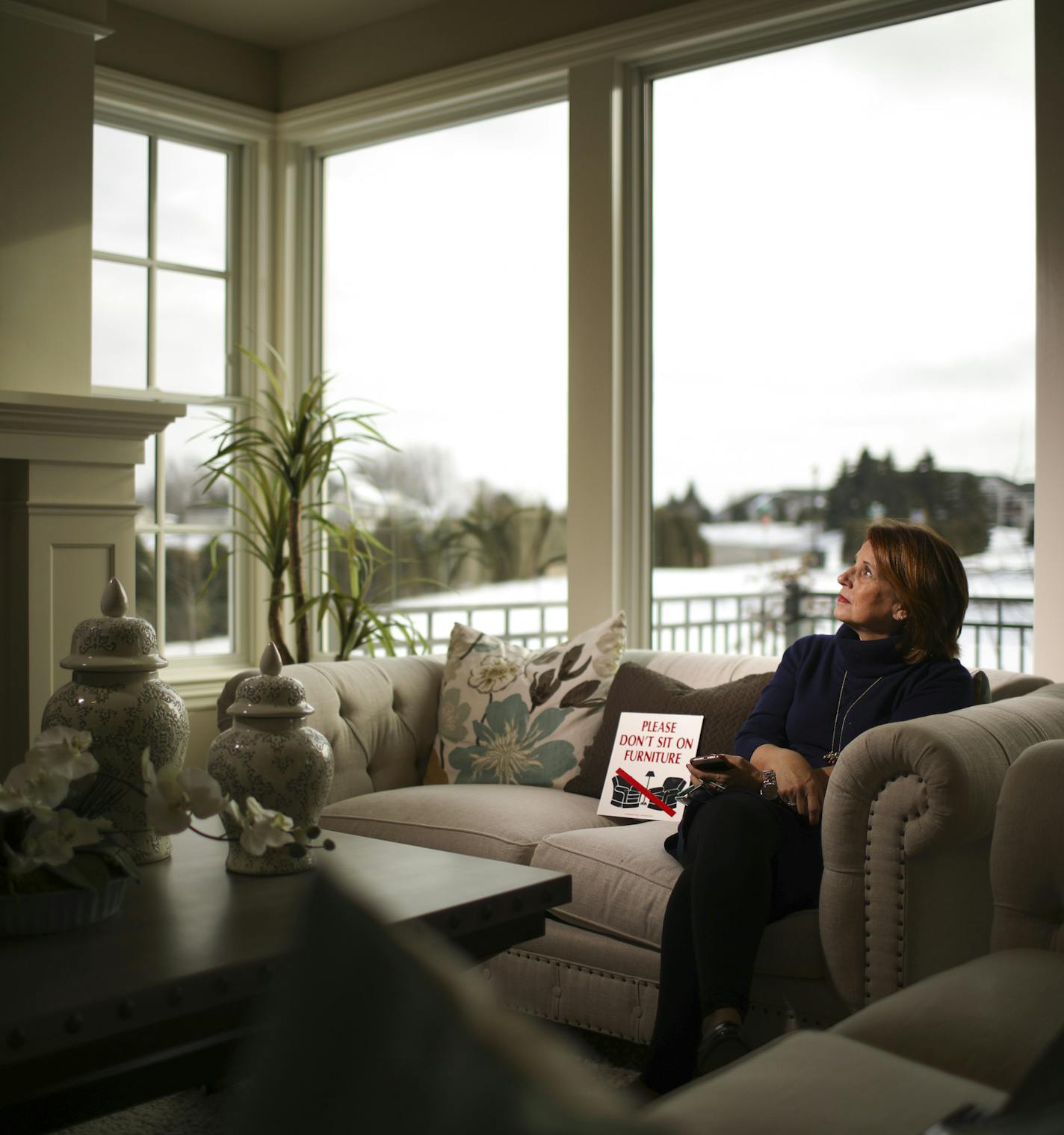 Kris Griswold Holmberg, 61, works as a homebuilder representative and often is alone as she waits for visitors to model homes, such as this one in Plymouth.