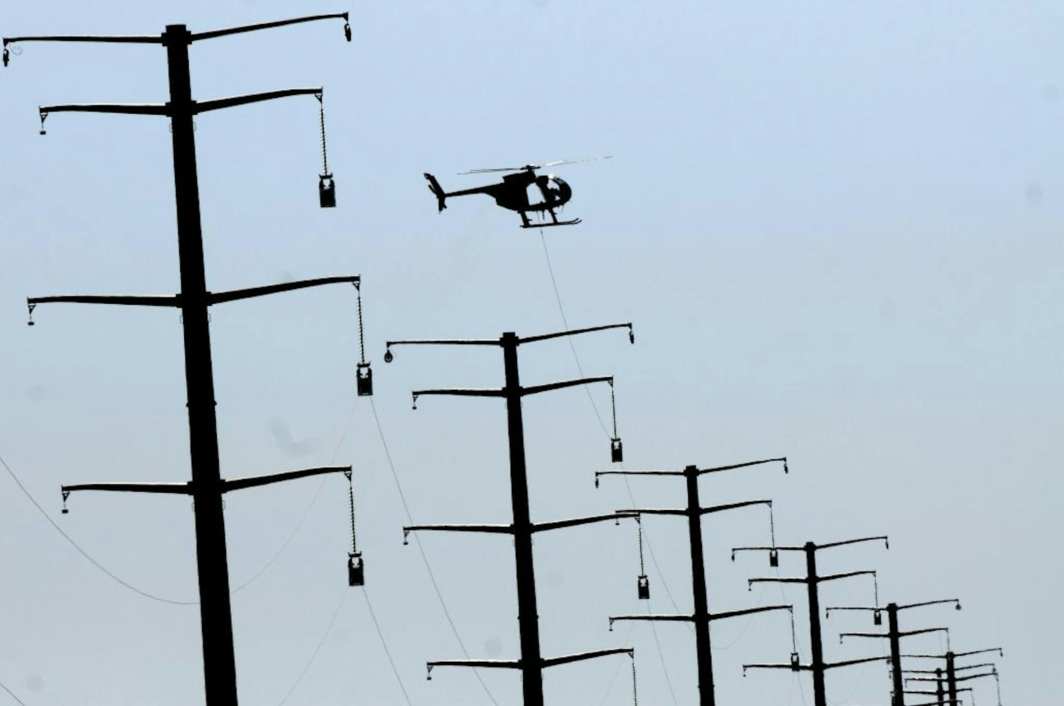 Xcel Energy power lines in Clearwater, Minn. Minneapolis will assess higher franchise fees against Xcel and CenterPoint Energy to help pay for climate and energy programs.