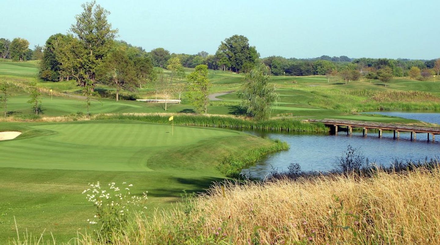 Windsong Farms' compact design, intended to encourage golfers to walk, allows players approaching the downhill par-3 green at No. 7 to see three other nearby greens, No. 2 (left), No. 17 (top center) and No. 14 (far right). golf course