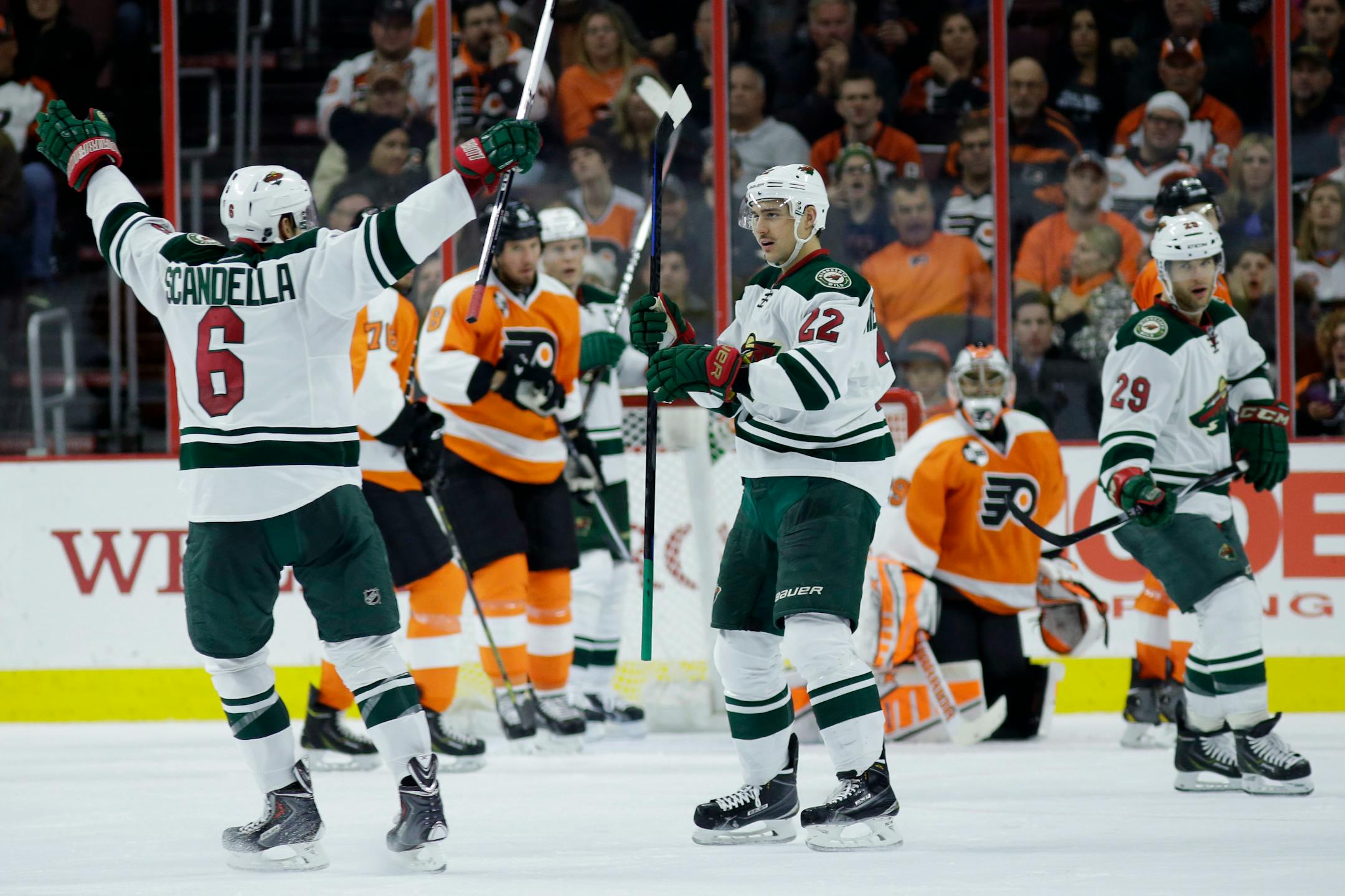 Minnesota Wild's Marco Scandella (6) and Nino Niederreiter (22), of the Czech Republic, celebrate after Niederreiter's goal during the second period of an NHL hockey game against the Philadelphia Flyers, Thursday, Nov. 20, 2014, in Philadelphia. (AP Photo/Matt Slocum)