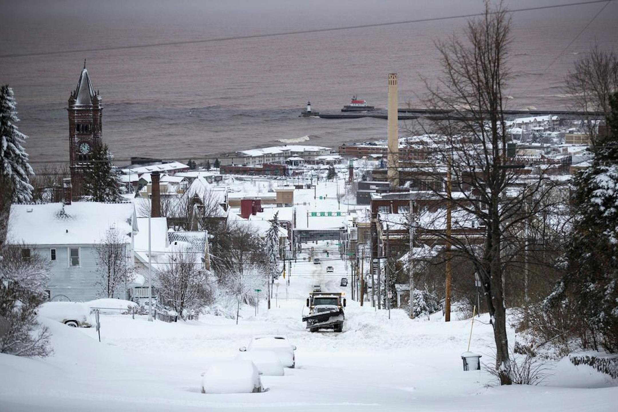 A snow plow moved up an icy Lake St. in Duluth on Sunday morning.