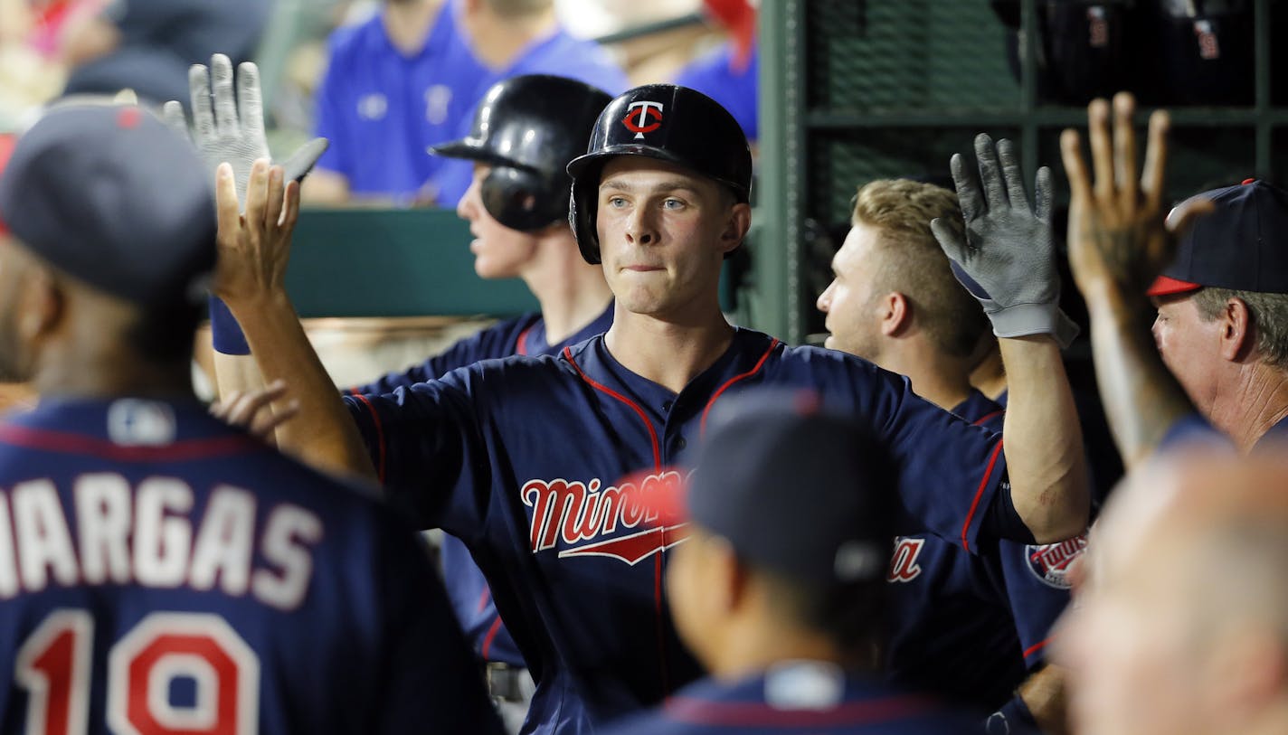 Minnesota Twins' Max Kepler is congratulated in the dugout after Kepler hit a two-run home run off of Texas Rangers relief pitcher Shawn Tolleson in the eighth inning of a baseball game, Thursday, July 7, 2016, in Arlington, Texas. (AP Photo/Tony Gutierrez)