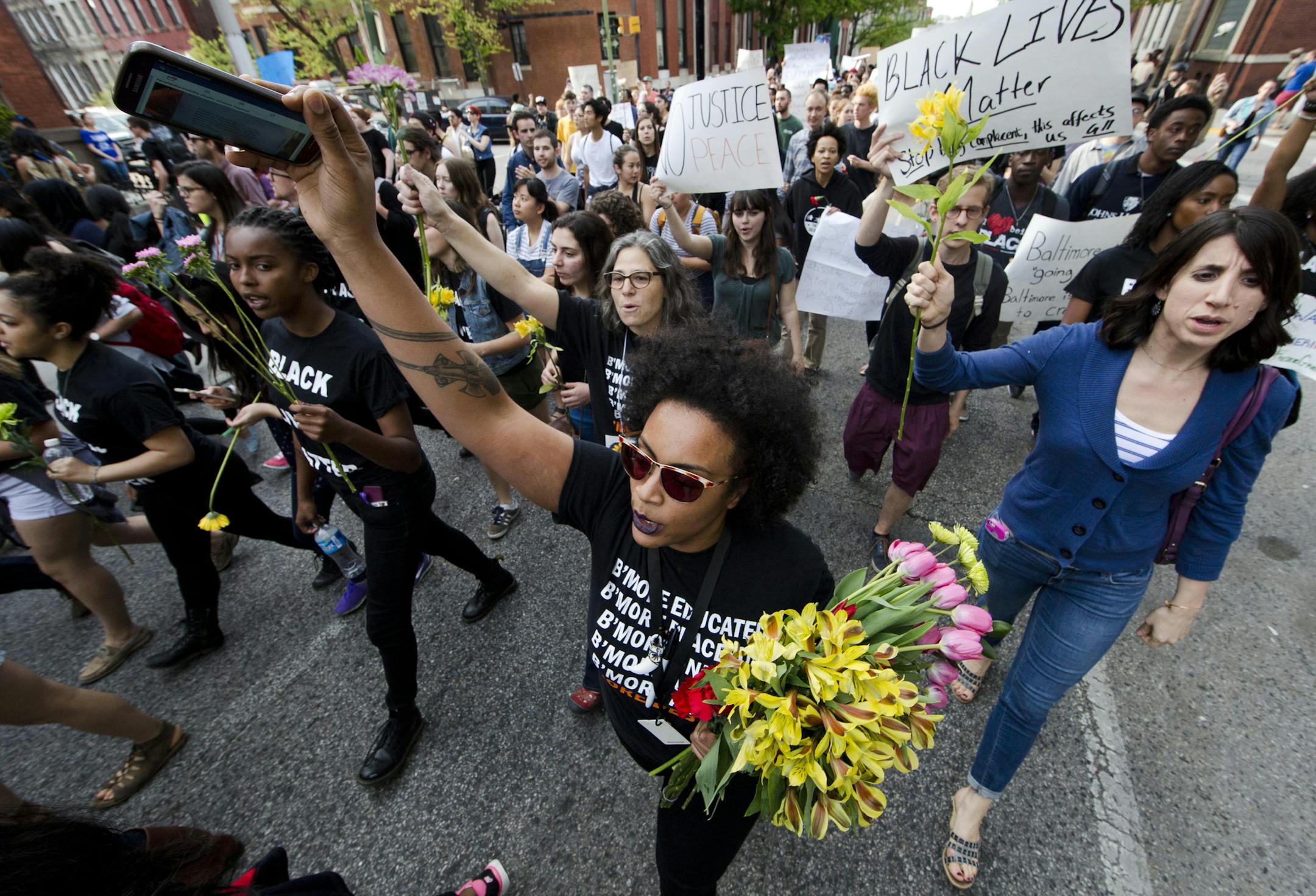 Protestors march Wednesday, April 29, 2015, in Baltimore. Hundreds of protesters, many of them students wearing backpacks, marched through downtown, calling for swift justice in the case of Freddie Gray, a black man who suffered critical injuries while in police custody. (AP Photo/Matt Rourke)