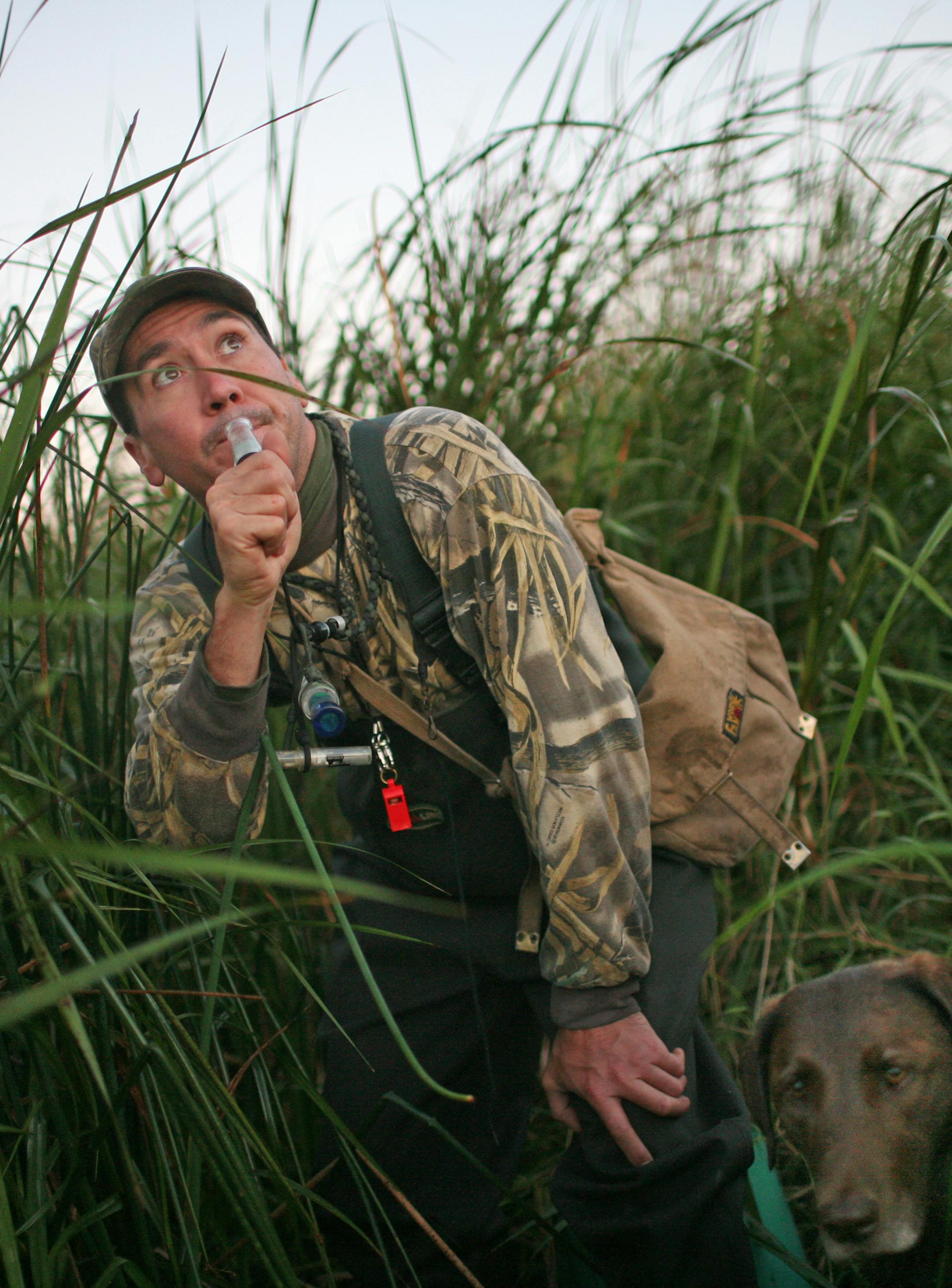 USFWS Wildlife Biologist Dave Fronczak uses a duck call to entice ducks in to the decoys. Jessie, his retriever, is a right. Fronczak accompanied Trevor Lenzen, 13, his dad Brian, and Nelson Brothers, 11, and his dad Hal, on the Saturday morning Youth Day waterfowl hunt. ] It was the youth Waterfowl Opener Saturday, and the Minnesota Waterfowl Association selected 18 kids and a parent for a morning's duck hunting in/near the Minnesota Valley Wildlife Refuge in the south metro. Hunters gathered a