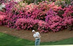 Rory McIlroy, of Northern Ireland, hits a chip on the 13th hole during practice for the Masters golf tournament at Augusta National Golf Club, Tuesday