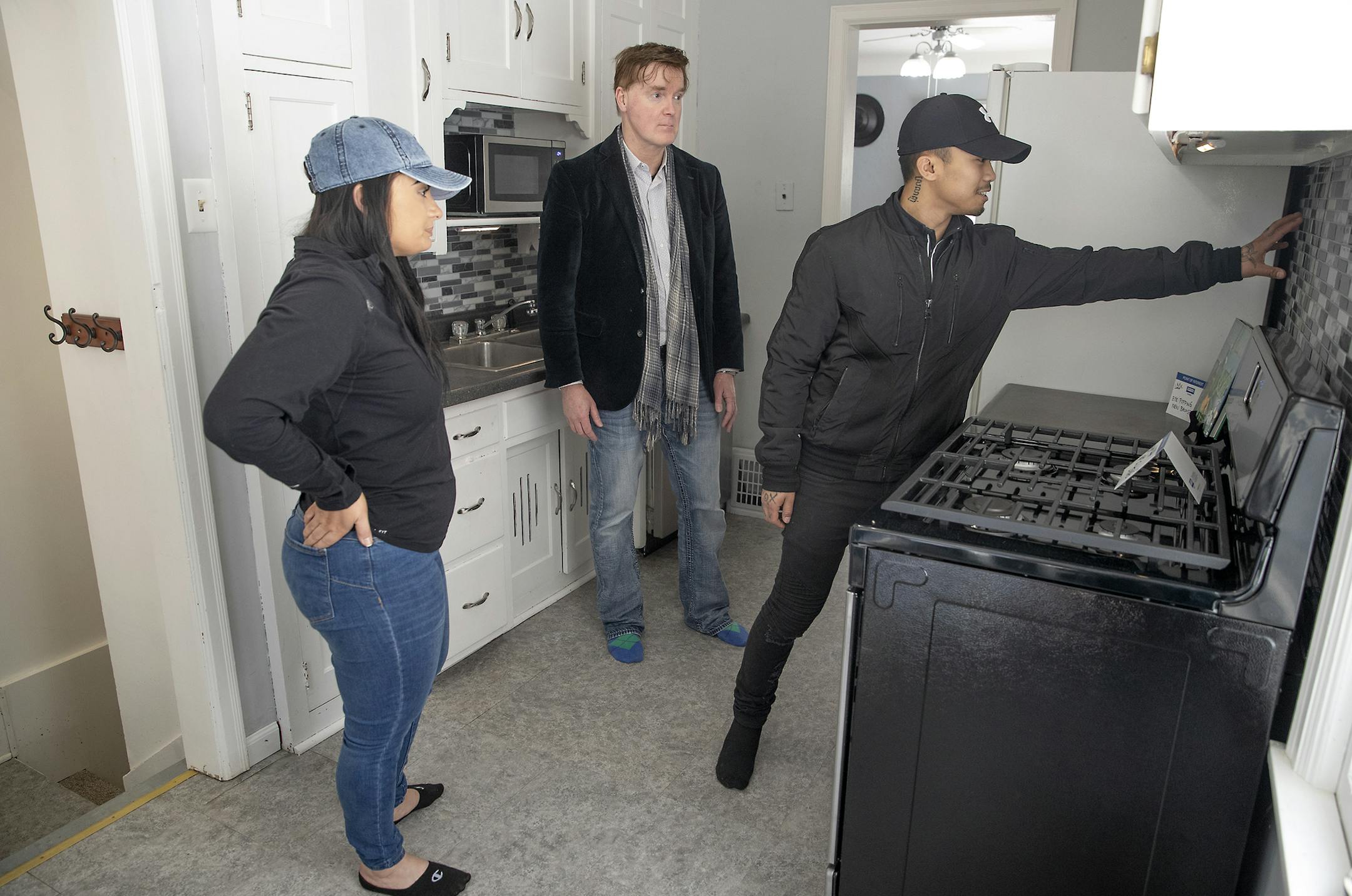 Realtor Clay Lowen, center, showed a home in Robbinsdale to first-time homeowners Brandon Chheoun and Gina Solt earlier in the month.