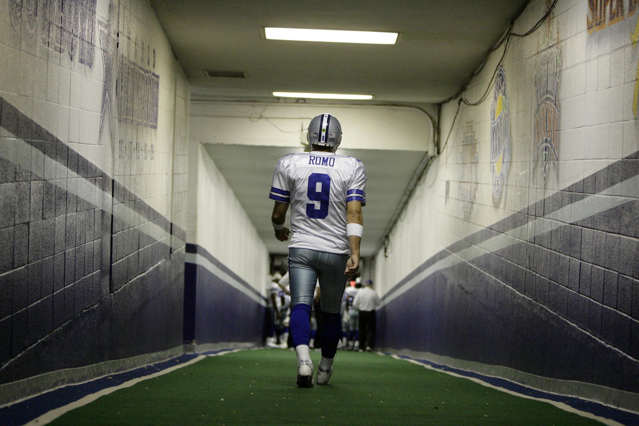 FILE - In this Dec. 20, 2008, file photo, Dallas Cowboys quarterback Tony Romo walks down the tunnel to the playing field at Texas Stadium before an NFL football game, in Irving, Texas. A person with knowledge of the decision says Romo is retiring rather than trying to chase a Super Bowl with another team after losing his starting job with the Cowboys. The all-time passing leader for the storied franchise is headed to the broadcast booth after considering those offers. The person spoke to The As