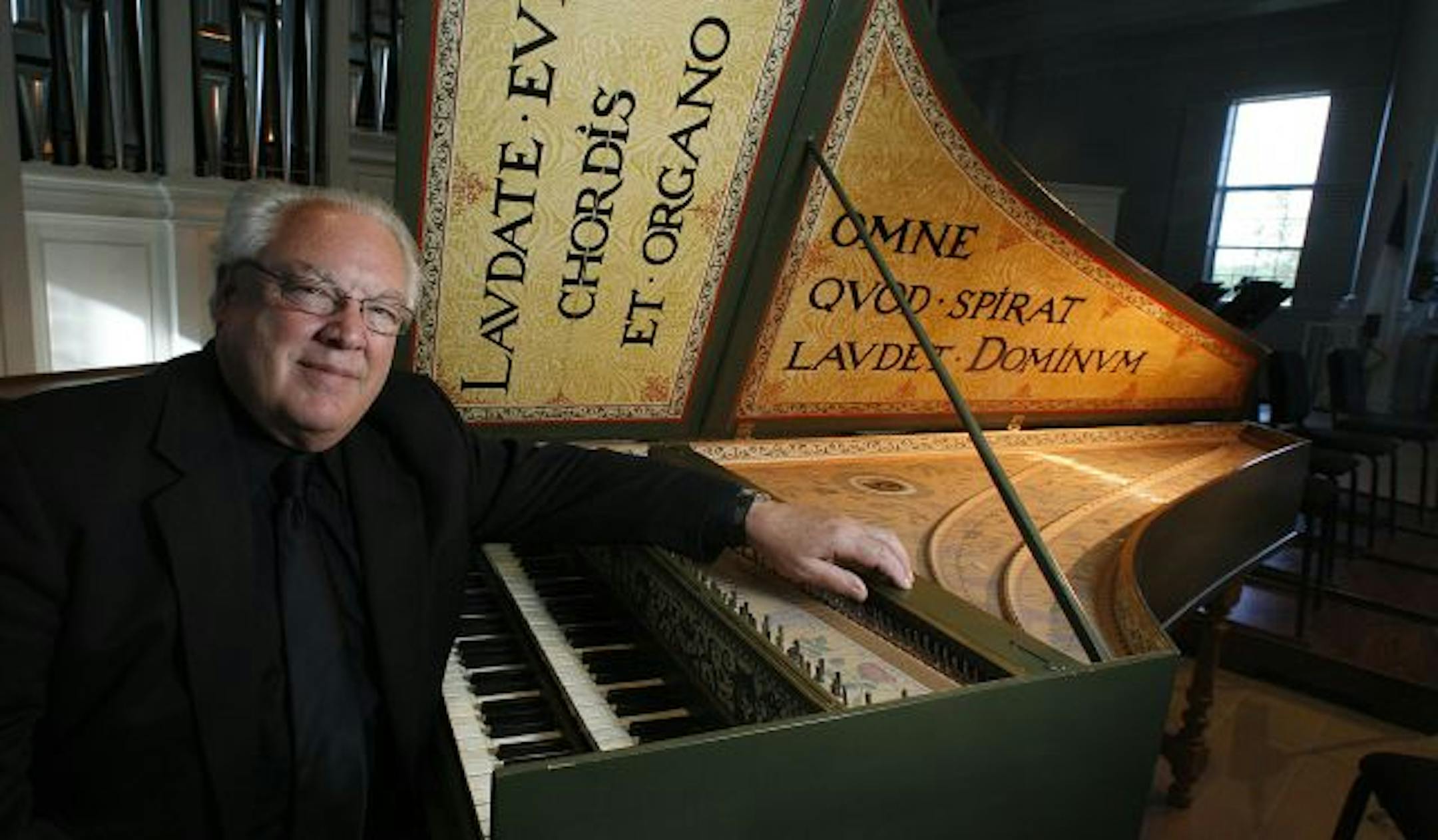 Layton James, shown with a harpsichord that he built.
