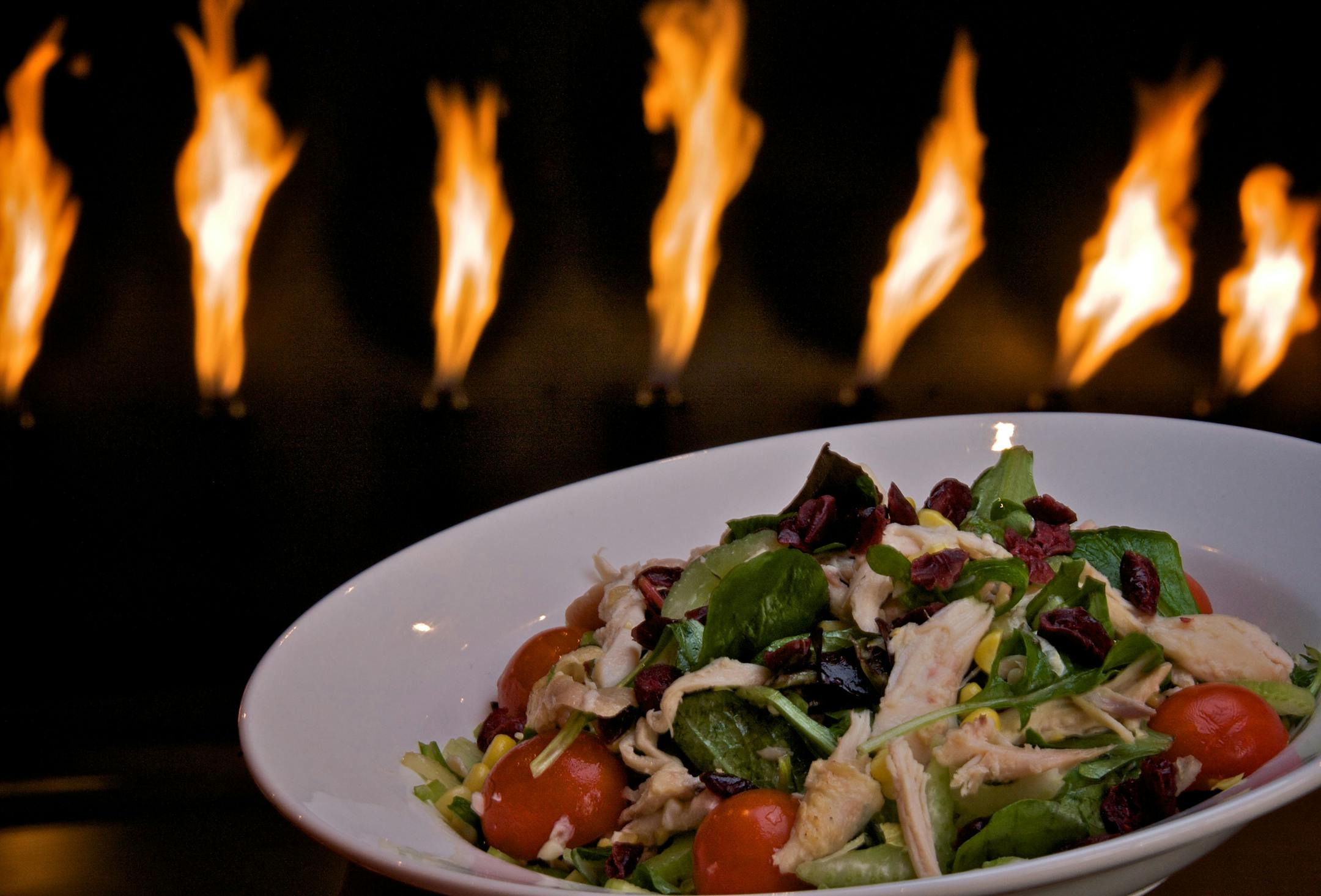 The best dish in the house: Juicy rotisserie chicken tossed with cherry tomatoes, craisins, roasted corn and field greens, finished with a lime vinaigrette.