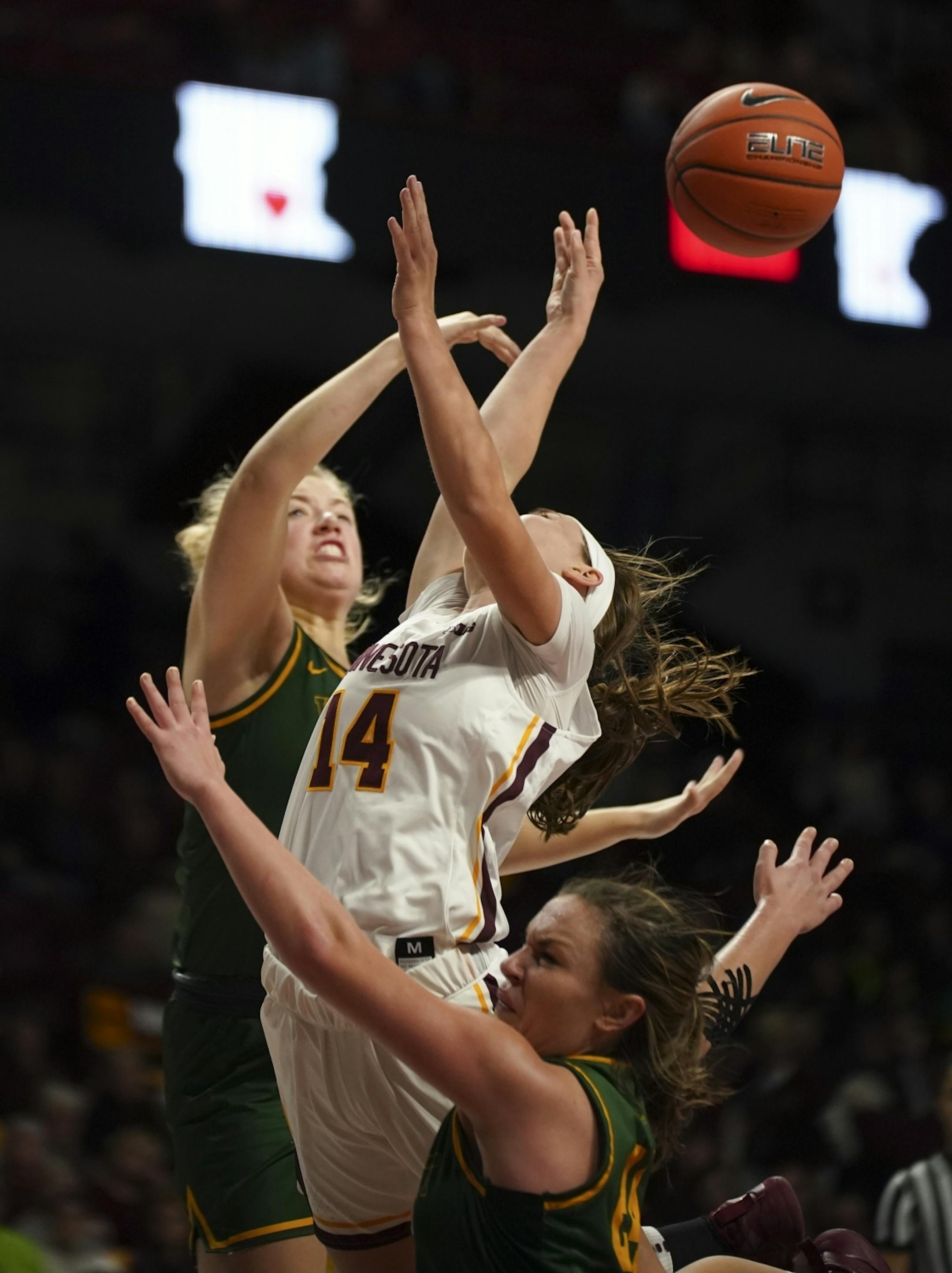 Minnesota Golden Gophers guard Sara Scalia (14) was stripped of the ball in the fourth quarter by Vermont Catamounts forward Abby Settelmeyer (25), left, and guard Rose Caverly (24), who drew the foul.