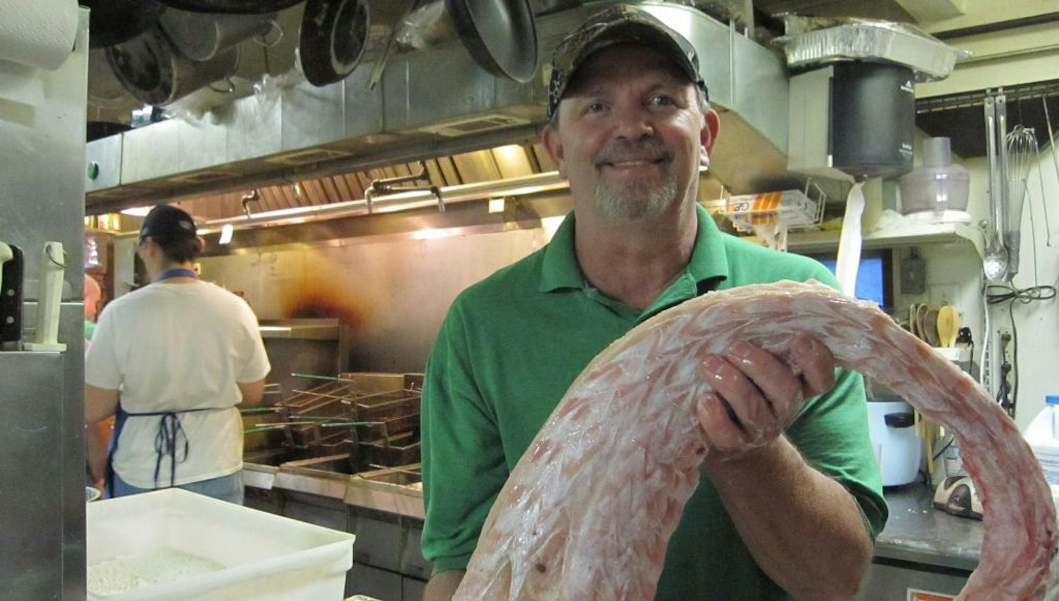 Ron McFarlain, owner of Cajun Connection, held a piece of alligator meat from his native Louisiana. "Everything is Louisiana here," he said.