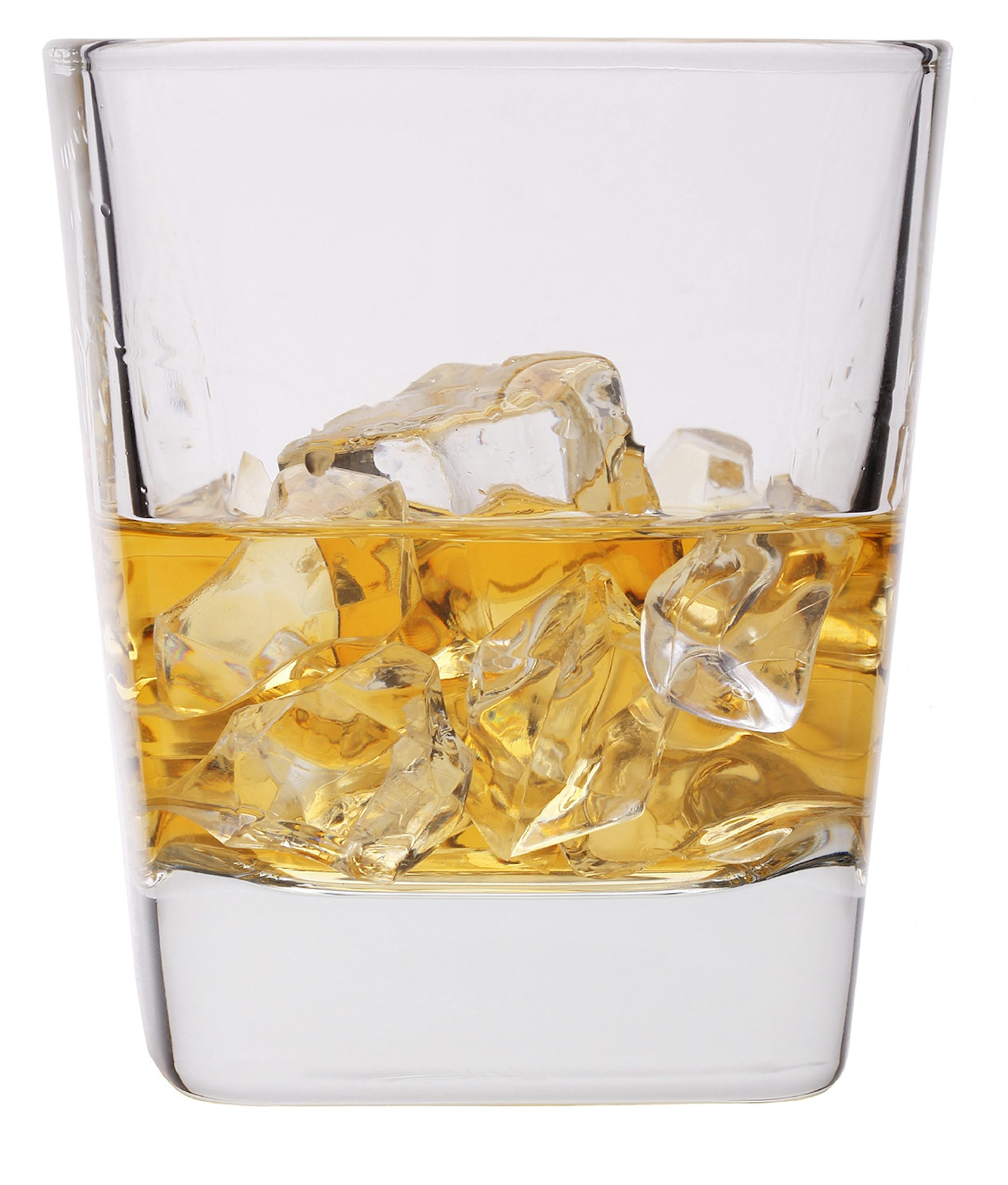 Glass of irish whiskey with ice cubes, isolated on white. From istock.