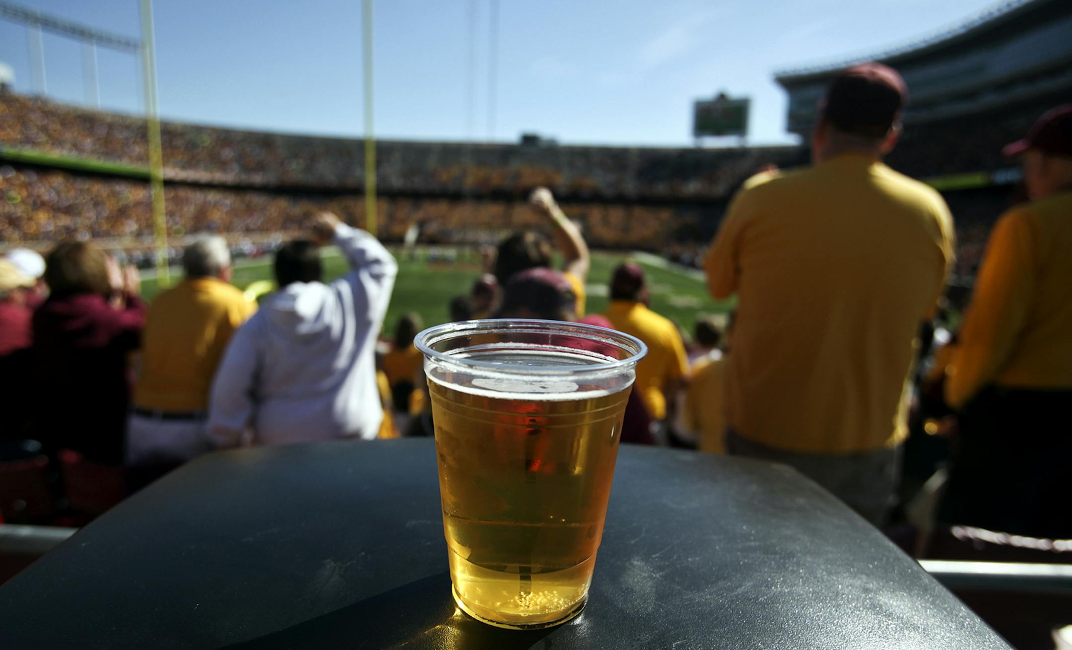 A beer sits atop a garbage can as Gopher fans cheer a long first quarter play against New Hampshire Saturday, Sept. 8, 2012, at TCF Bank Stadium in Minneapolis, MN.] (DAVID JOLES/STARTRIBUNE) djoles@startribune.com Beer flowed for the first time at a University of Minnesota football game at TCF Bank Stadium Saturday, Sept. 8, 2012 in Minneapolis. ORG XMIT: MIN1209081447402730 ORG XMIT: MIN1303221405260460