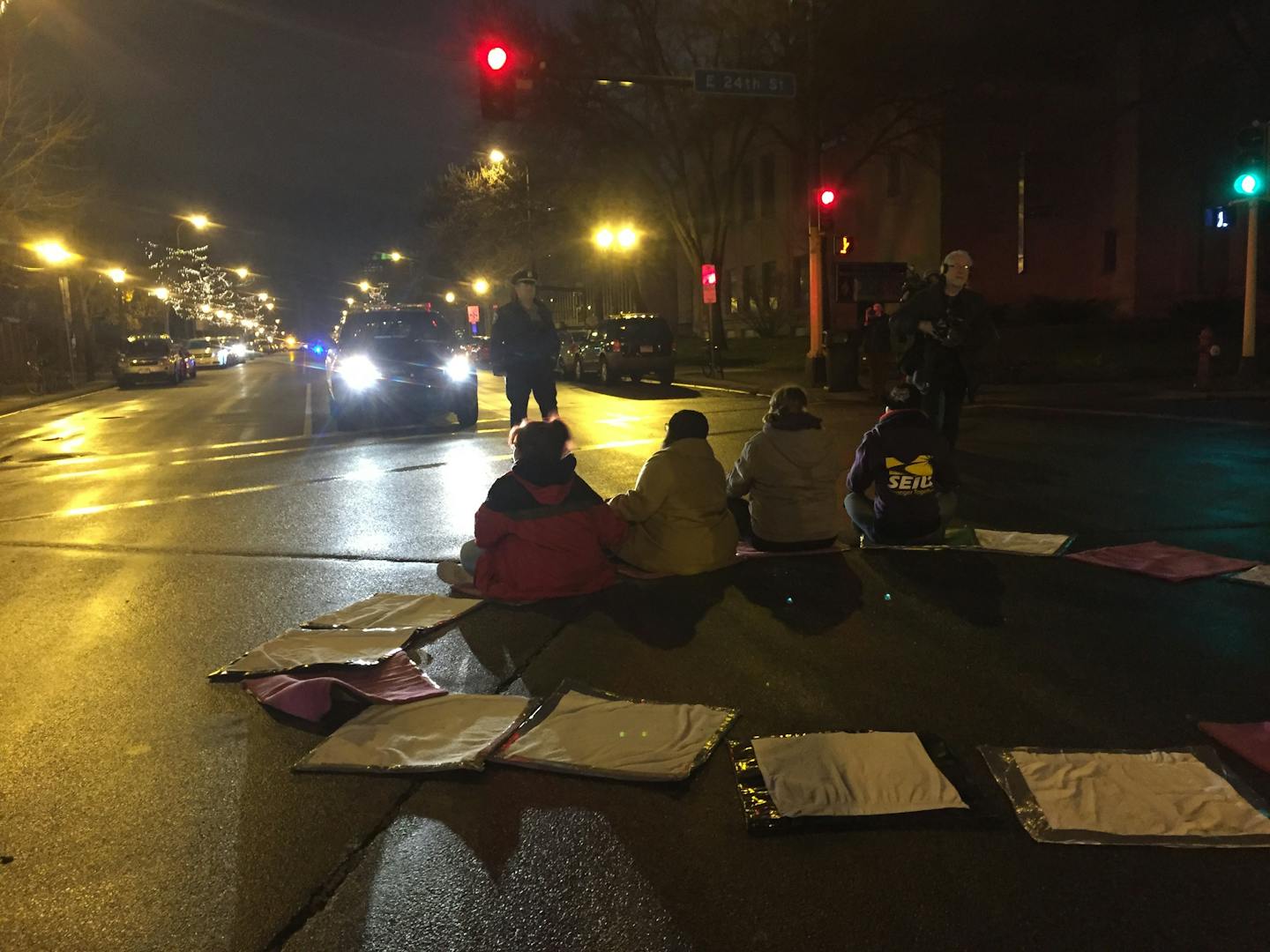 Protestors wait to be arrested during a national protest for $15 an hour Tuesday outside a McDonald's in Minneapolis.