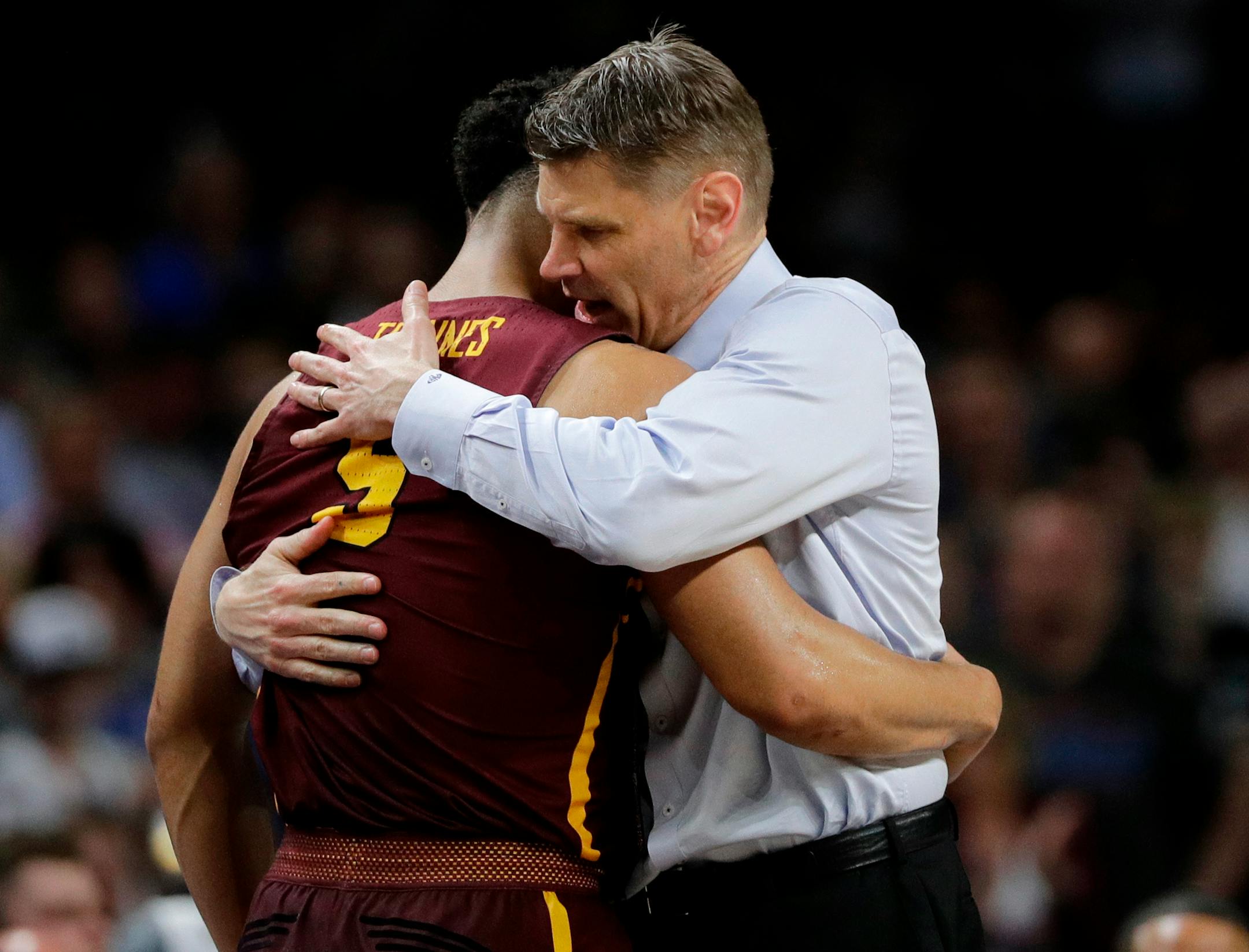 Loyola-Chicago head coach Porter Moser hugs Marques Townes (5) during the second half in the semifinals of the Final Four NCAA college basketball tournament against Michigan, Saturday, March 31, 2018, in San Antonio. (AP Photo/David J. Phillip)