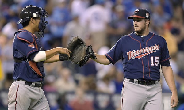 Twins closer Glen Perkins, right, received congratulations from catcher Kurt Suzuki after getting the save in Tuesday's 2-1 victory at Kansas City.