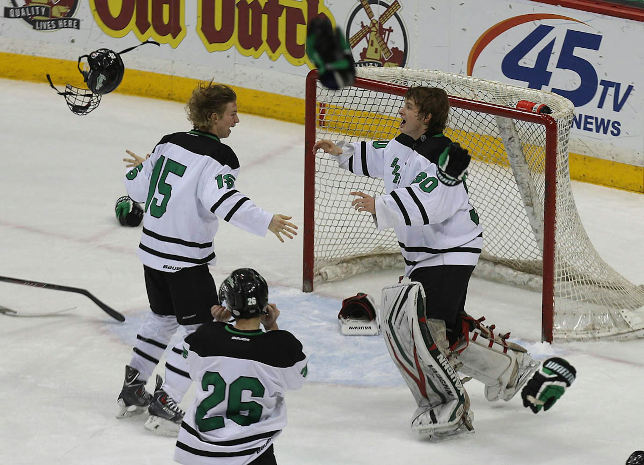 East Grand Forks players Josh Weber (right) and Trevor Selk threw their equipment in the air as the final buzzer sounded to end the game.