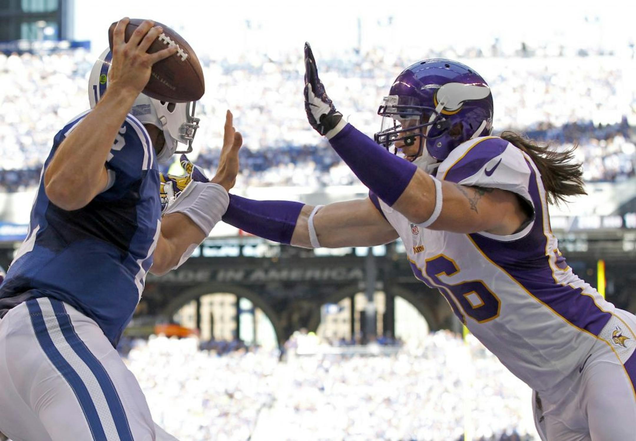 Colts quarterback Andrew Luck evaded the grasp of Brian Robison in the end zone in the third quarter.