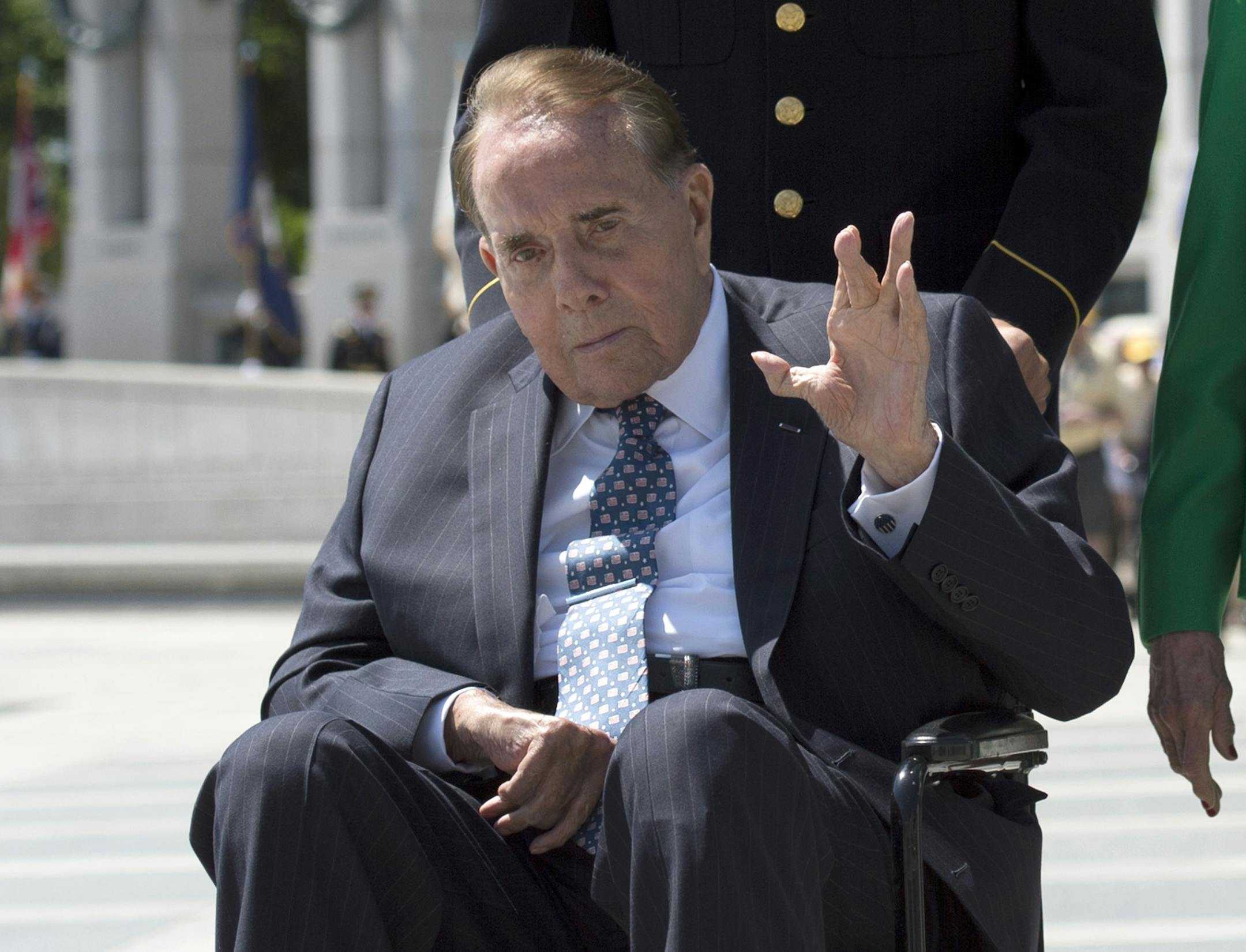 WWII veteran and former Senate Majority Leader Bob Dole waves after taking part in a wreath laying ceremony at a 10th anniversary ceremony for the WWII Memorial in Washington, Saturday, May 24, 2014. (AP Photo/Molly Riley)