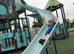 Max Lewis, 8, takes a slide at PK's Place, next to Alianz Field, a few blocks from his home on June 28.