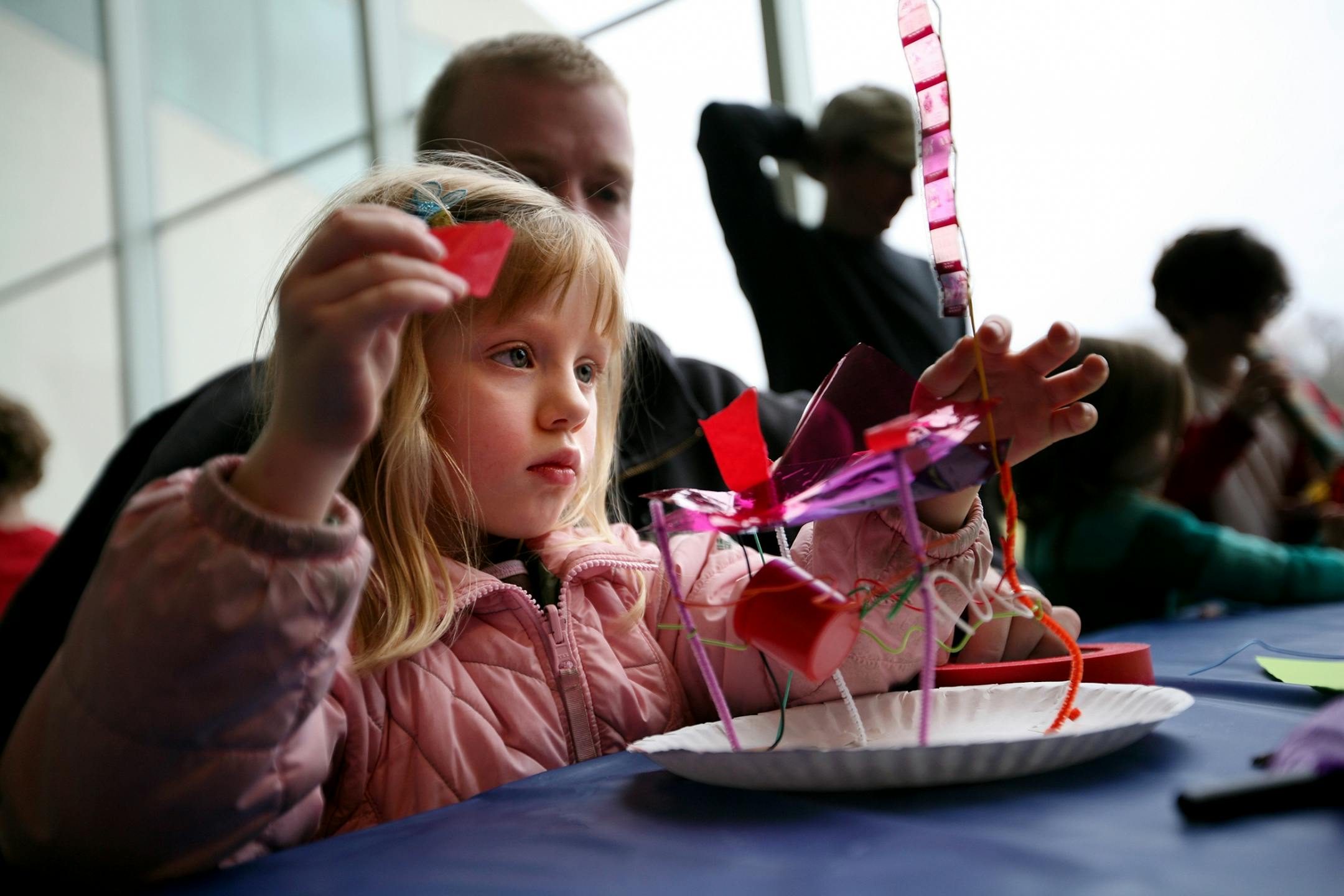 Olivia Gibson, 4, creates a spider web with a light and various transparent materials during Free Saturday at the Walker Art Center Nov. 3, 2012.