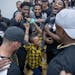 Minnesota Vikings players surrounded Richard Green Central Park Community School student Jayden Mcafee as they celebrated reaching their goal of packi