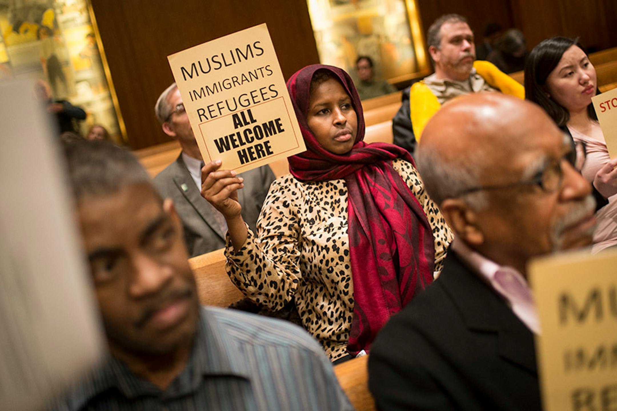 Farhio Khalif, an immigrant from Somalia, held a sign voicing her support for a city council resolution condemning Republican presidential candidate Donald Trump for anti-Muslim, anti-refugee and anti-immigrant speech Wednesday night.