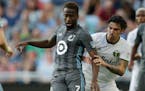 Minnesota United midfielder Kevin Molino (7) controls the ball in front of Portland Timbers defender Zarek Valentin (16) in the first half of a U.S. O