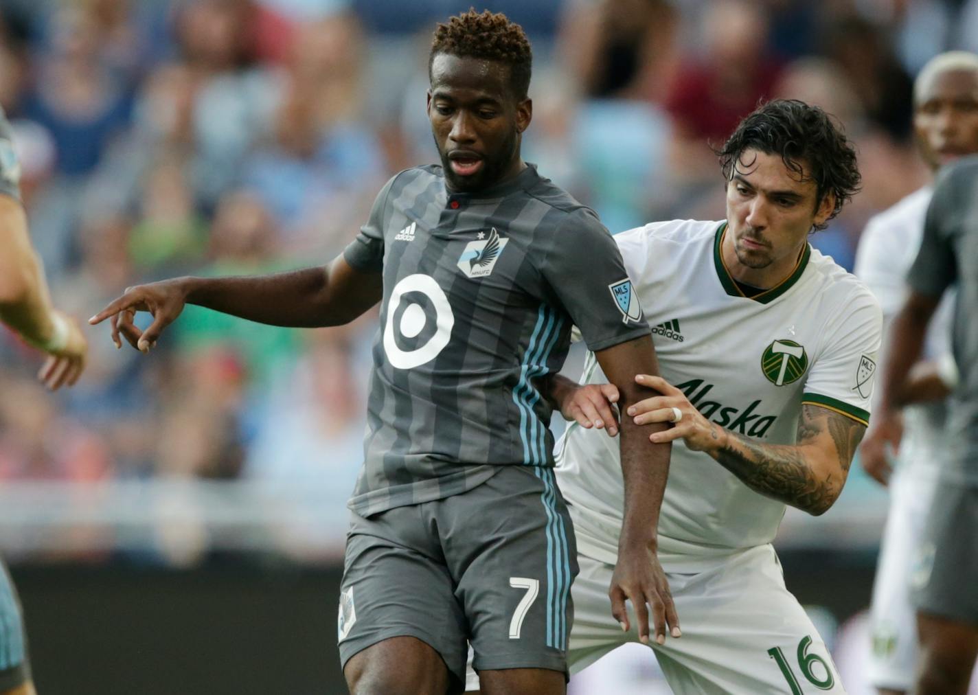 Minnesota United midfielder Kevin Molino (7) controls the ball in front of Portland Timbers defender Zarek Valentin (16) in the first half of a U.S. Open Cup soccer semifinal Wednesday, Aug. 7, 2019, in St. Paul, Minn. (AP Photo/Andy Clayton- King)