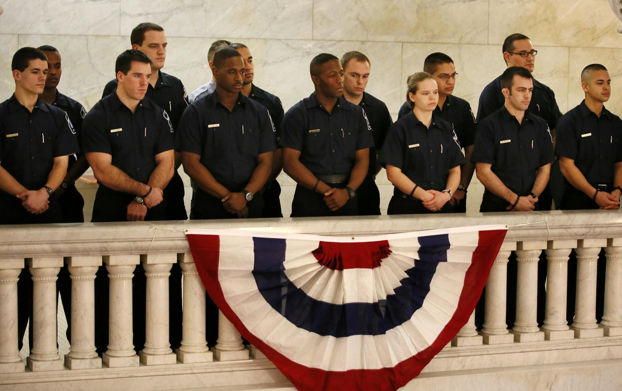 New Minneapolis Police Chief Janee Harteau was swarn in Tuesday afternoon in the City Hall Routunda. Here, fellow officers watch the ceremony from the balcony.