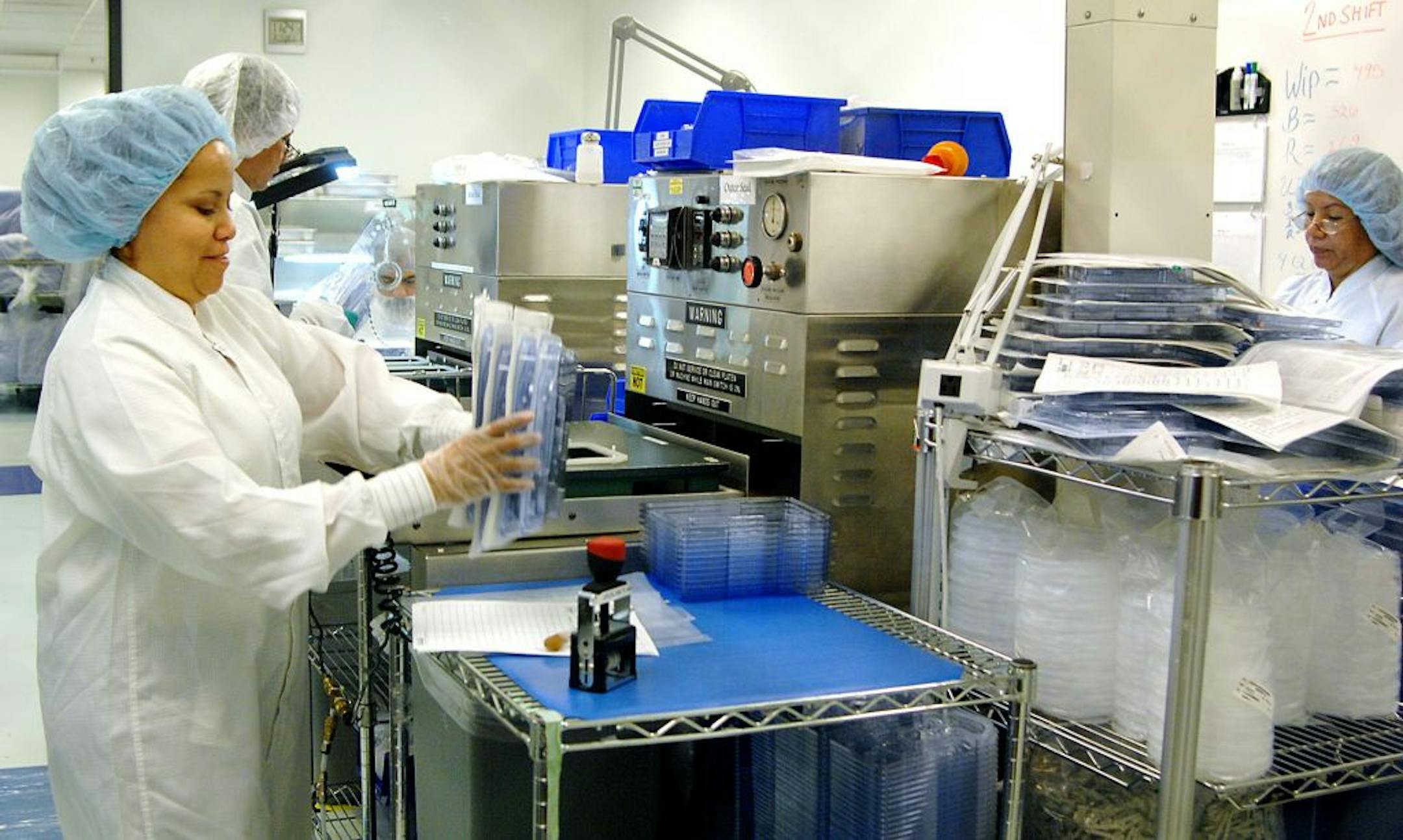 Employees work in the packaging room at the Cardiac Rhythm Management Division facility of St. Jude Medical in Sylmar, Calif.